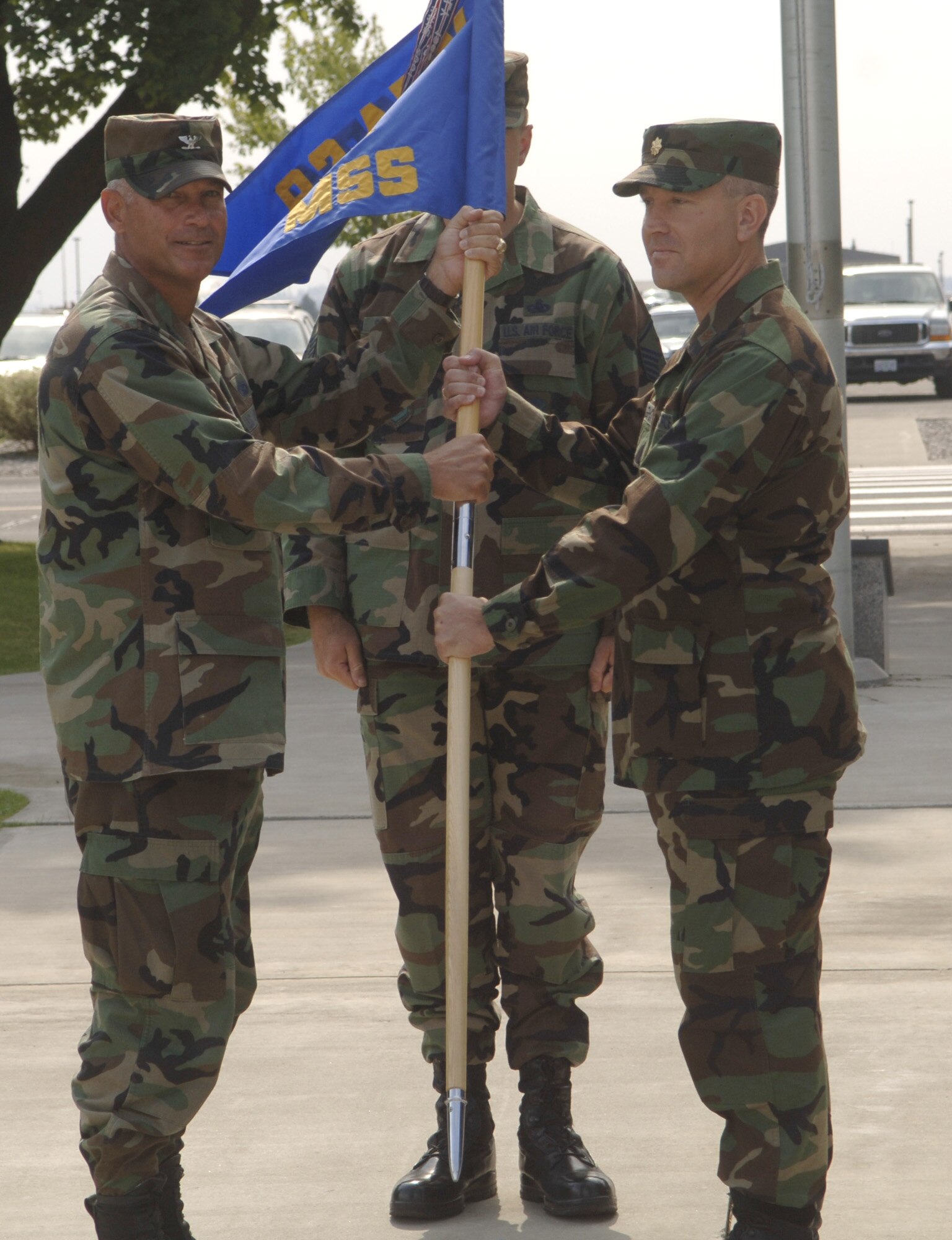FAIRCHILD AIR FORCE BASE, Wash. – Col. Van Fuller, 92nd Mission Support Group commander, passes the 92nd Mission Support Squadron flag to Maj. Jason Knight, new 92nd MSS commander. Major Knight received command of the squadron from Lt. Col. David Stenglein during the change of command ceremony here Aug. 16. (U.S. Air Force photo / Senior Airman Chad Watkins)