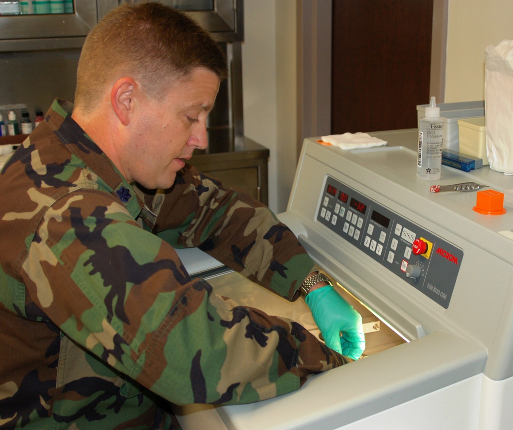 Using a Cryostat, Colonel Ritter cuts frozen skin sections to prepare them for staining for viewing under a microscope to find cancer cells that may be present.  (U.S. Air Force photo by Steve Pivnick)