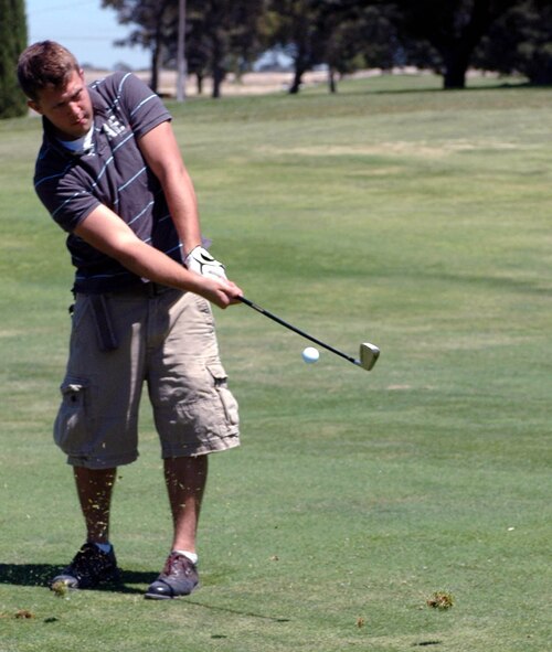Matthew Brattoli takes his approach shot on the 16th hole during the 60th Air Force Anniversary Golf Tournament at the Cypress Lakes Golf Course Aug. 17. Tournament participants competed for prizes worth more than $6,000, including a Tahoe vacation package. (U.S. Air Force photo/Staff Sgt. Candy Knight)
