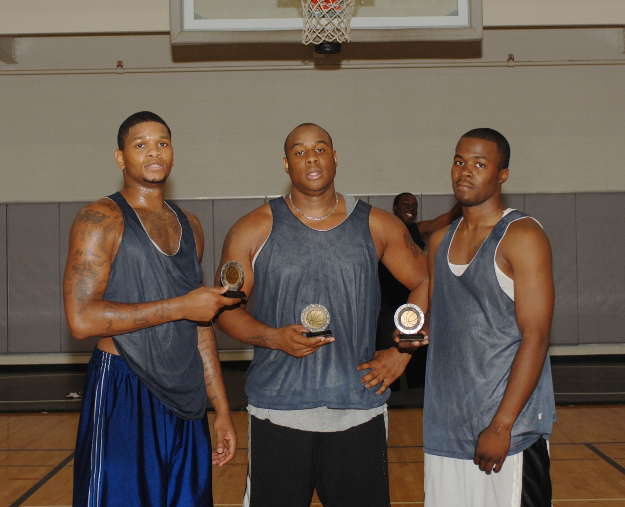 DYESS AIR FORCE BASE, Texas-- (Left to right) Jonathan Battle and Senior Airmen Nathaniel Bias and David Owens, 7th Medical Group, show off their trophies after a close 23-to-21, three-on-three basketball tournament Aug. 18. The tournament lasted approximately four and a half hours. (U.S. Air Force photo by Senior Airman Courtney Garrard)