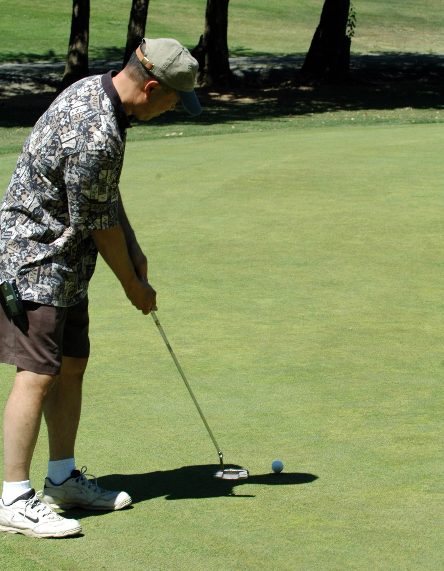 Giovanni Tuck, 60th Air Mobility Wing vice commander, takes a few practice putts before the 60th Air Force Anniversary Golf Tournament at the Cypress Lakes Golf Course Aug. 17. Proceeds from the tournament will be used for the 60th Air Force Anniversary Ball, Sept. 14. (U.S. Air Force photo/Staff Sgt. Candy Knight)