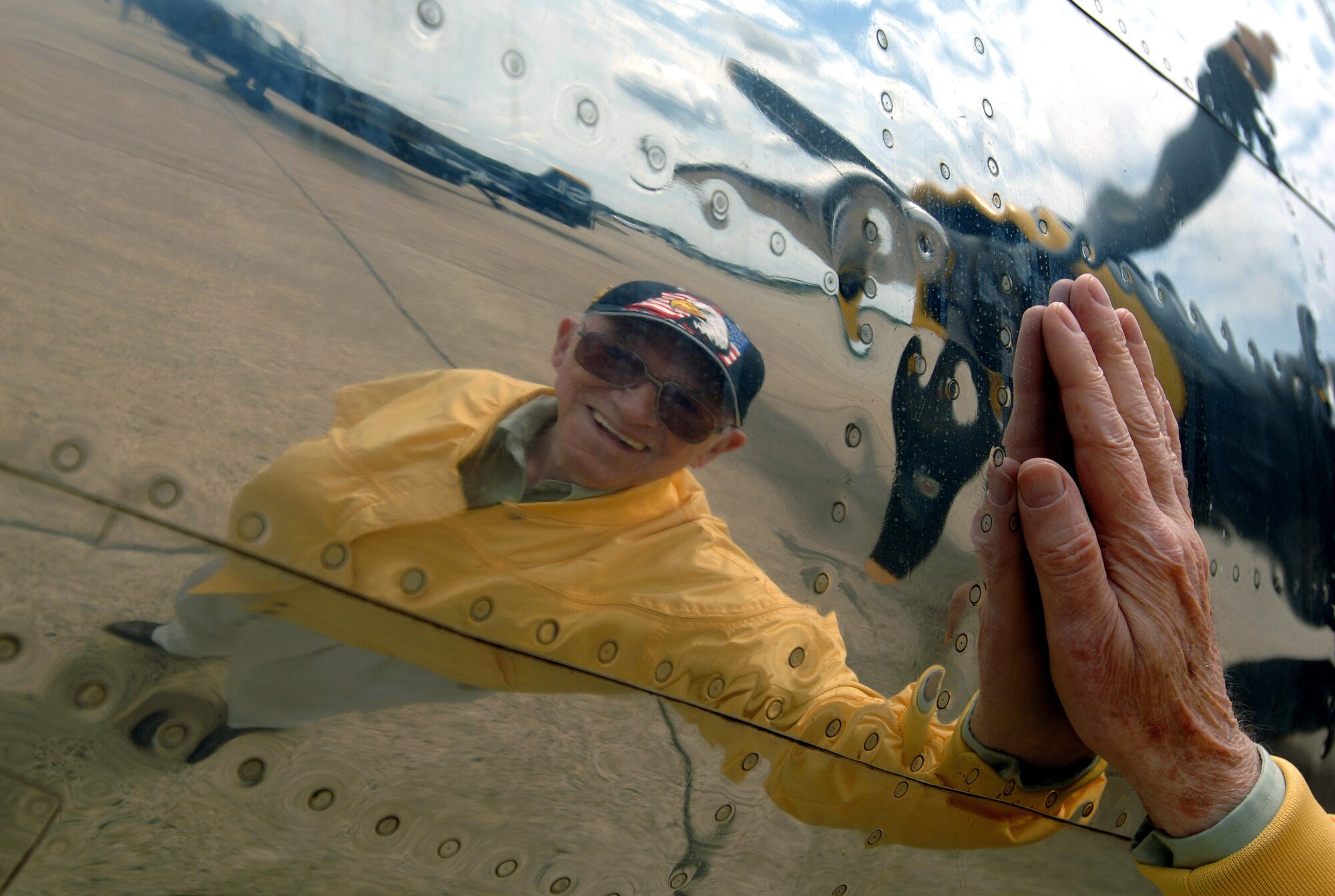 World War II veteran Robert McNally rubs his had against the "Miss Hap," the oldest flying B-25 Mitchell bomber in the world Aug. 19 at Pease Air National Guard Base at Portsmouth, N.H. The "Miss Hap" was the personal aircraft of Gen. Henry "Hap" Arnold, the commanding officer of the Army Air Corps during WW II. Mr. McNally was an aircraft radio operator in the Army Air Corps and routinely flew aboard B-25s during WW II. Mr. McNally, 81, was a guest attending the 2007 Wings of Hope Air Show with hopes of being reunited with old friends. The 2007 Wings of Hope Air Show at Pease ANGB is in conjunction with Air Force Week New England. (U.S. Air Force photo/Staff Sgt. Bennie J. Davis III) 

