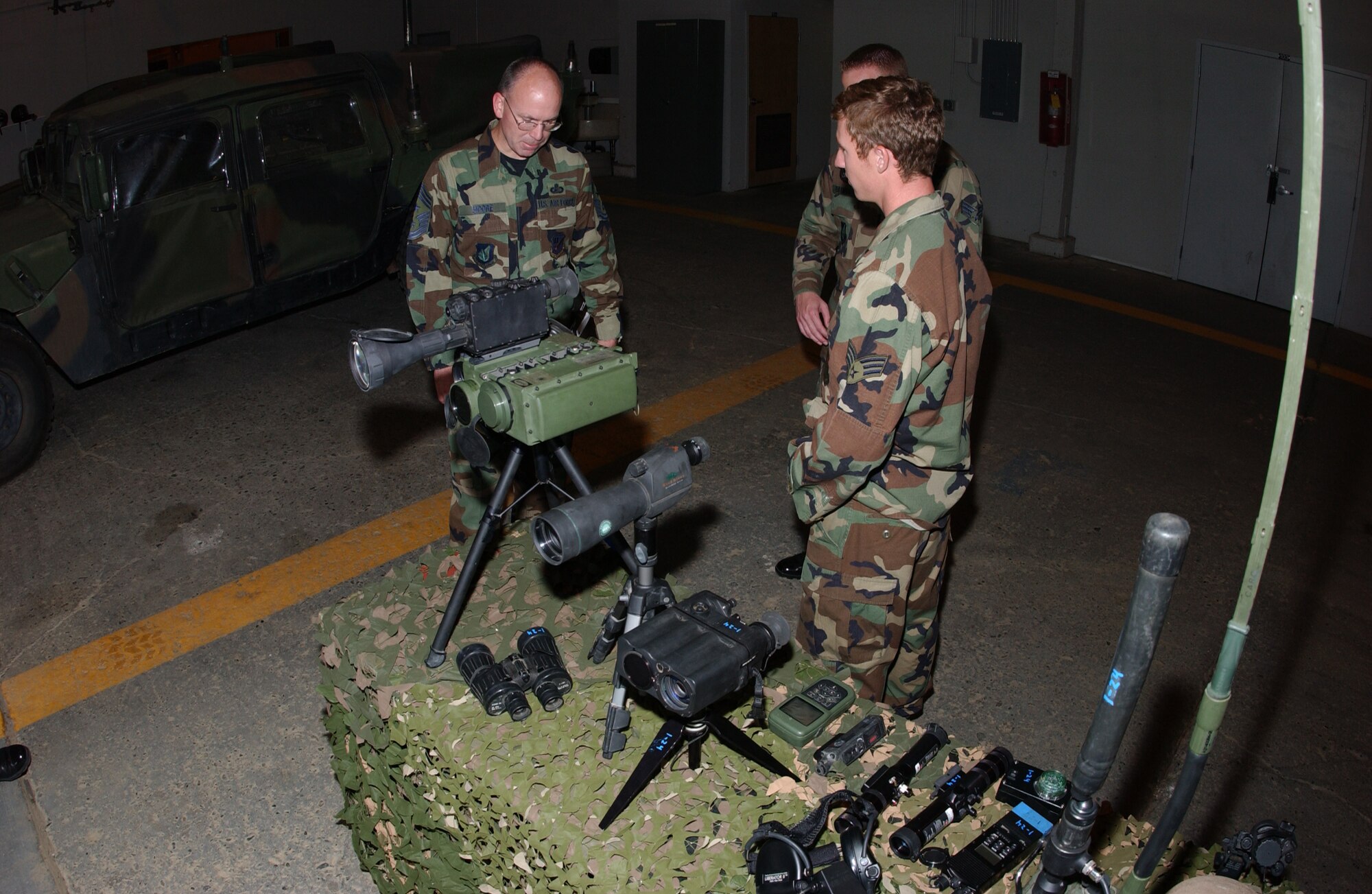 EIELSON AIR FORCE BASE, Alaska -- Senior Airman Neal Habershaw (right), 3rd Air Support Operations Squadron Tactical Air Control Party, gives a presentation of their equipment used in the field to Chief Master Sgt. Robert Moore (left), 11th Air Force command chief, Aug. 16 at the 3rd ASOS TACP facility on Fort Wainwright. Chief Moore is visiting Airmen of TACP to inspect working conditions of the facility. (U.S. Air Force Photo by Airman 1st Class Jonathan Snyder)(Released)