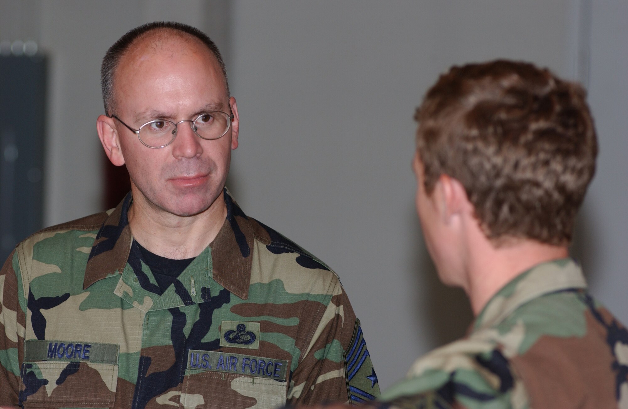 EIELSON AIR FORCE BASE, Alaska -- Senior Airman Neal Habershaw (front), 3rd Air Support Operations Squadron Tactical Air Control Party, gives a presentation to Chief Master Sgt. Robert Moore (back), 11th Air Force command chief, Aug. 16 at the 3rd ASOS TACP facility on Fort Wainwright. Chief Moore is visiting Airmen of TACP to inspect working conditions of the facility. (U.S. Air Force Photo by Airman 1st Class Jonathan Snyder)(Released)