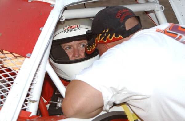 Janet Tucker speaks to her husband Maj. Matt Tucker, 341st Space Wing plans chief, before her first race in the pure-stock class at the Electric City Speedway July 4. Mrs. Tucker finished ninth out of 16 competitors in her first night racing. (U.S. Air Force photo/Airman 1st Class Dillon White).