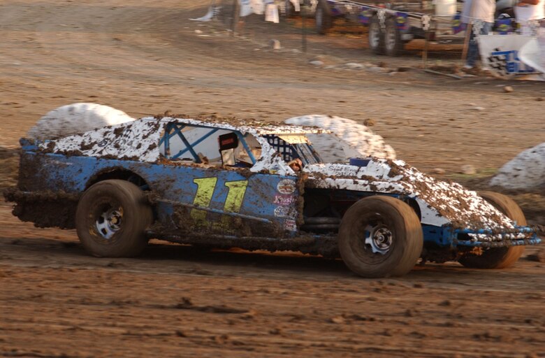 Kevin Rinehart, 341st Security Support Squadron combat arms instructor, drives the number 11 modified car during a pre-race practice session at the Electric City Speedway July 4. The retired Air Force master sergeant is racing in his rookie year and the car is owned by his friend Joe Bradley, 341st Civil Engineer Squadron mechanical engineer. (U.S. Air Force photo/Airman 1st Class Dillon White).
