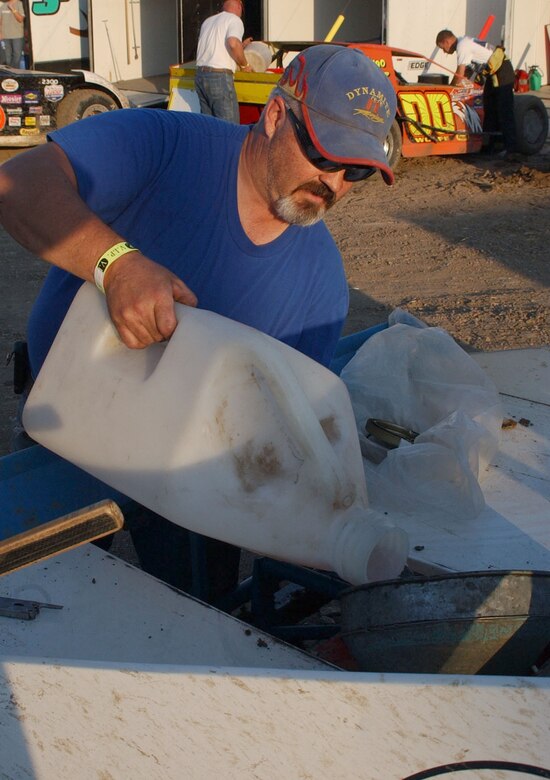 Joe Bradley, 341st Civil Engineer Squadron mechanical engineer, adds fuel to the number 11 modified car that he owns. Kevin Rinehart, 341st Security Suport Squadron combat arms instructor, drives the number 11 car. The two friends focus on having fun and being safe while competing at the Electric City Speedway in Great Falls, Mont. (U.S. Air Force photo/Airman 1st Class Dillon White).