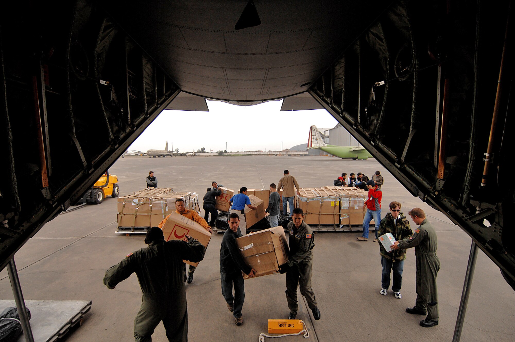 Crew members of the 135th Airlift Squadron from Baltimore and aid workers load earthquake relief supplies onto a C-130 Hercules Aug. 19 in Lima, Peru. The supplies will be taken to the victims of an 8.0 magnitude earthquake that hit parts of Western Peru Aug. 15, and took the lives of more than 500 people and injured more than 1,500. Around 80,000 Peruvians have been affected by the earthquake, and 80 percent of the homes were destroyed in the city of Pisco. (U.S. Air Force photo/Tech. Sgt. Jeremy Lock) 

