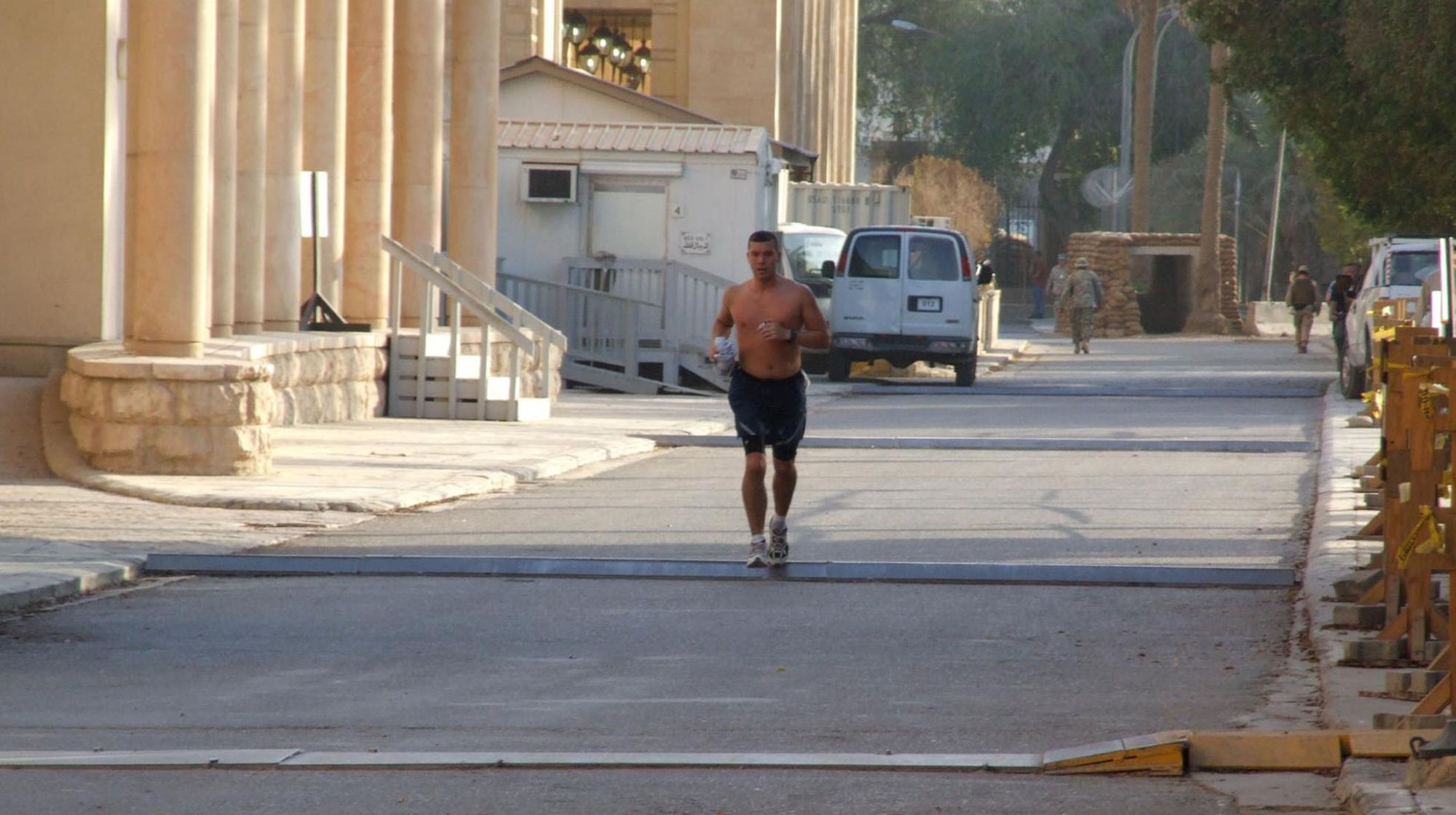 Capt. James Druell runs a 5-kilometer route through the U.S. Embassy grounds Aug. 12 in Baghdad while participated in the Santa Cruz Sprint Triathlon which takes place in California. Captain Druell is deployed from the 341st Operations Support Squadron at Malmstrom Air Force Base, Mont., and competed side-by-metaphoric-side in a triathlon, helping other servicemembers in his area of responsibility compete in the triathlon in the International Zone. Captain Druell's finishing time was 1 hour, 23 minutes, 37 seconds. (Courtesy photo).