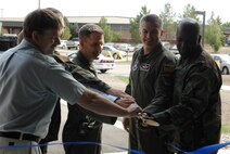 MINOT AIR FORCE BASE, N.D. -- (from left) Arthur Nyberg and Cols. Glen Lang, Greg Bell, Marty Whelan and Myron Freeman, cut a ribbon to the new 91st Security Forces Group building here Aug. 17. The $7.8 million security forces vehicle facility, dubbed “The Defender Dome” by Col. Marty Whelan, 91st Space Wing commander, provides protected parking for vehicles, three enclosed wash bays, equipment storage, dispatch operations, support offices and a training room. (U.S. Air Force photo by Senior Airman Christopher Boitz)