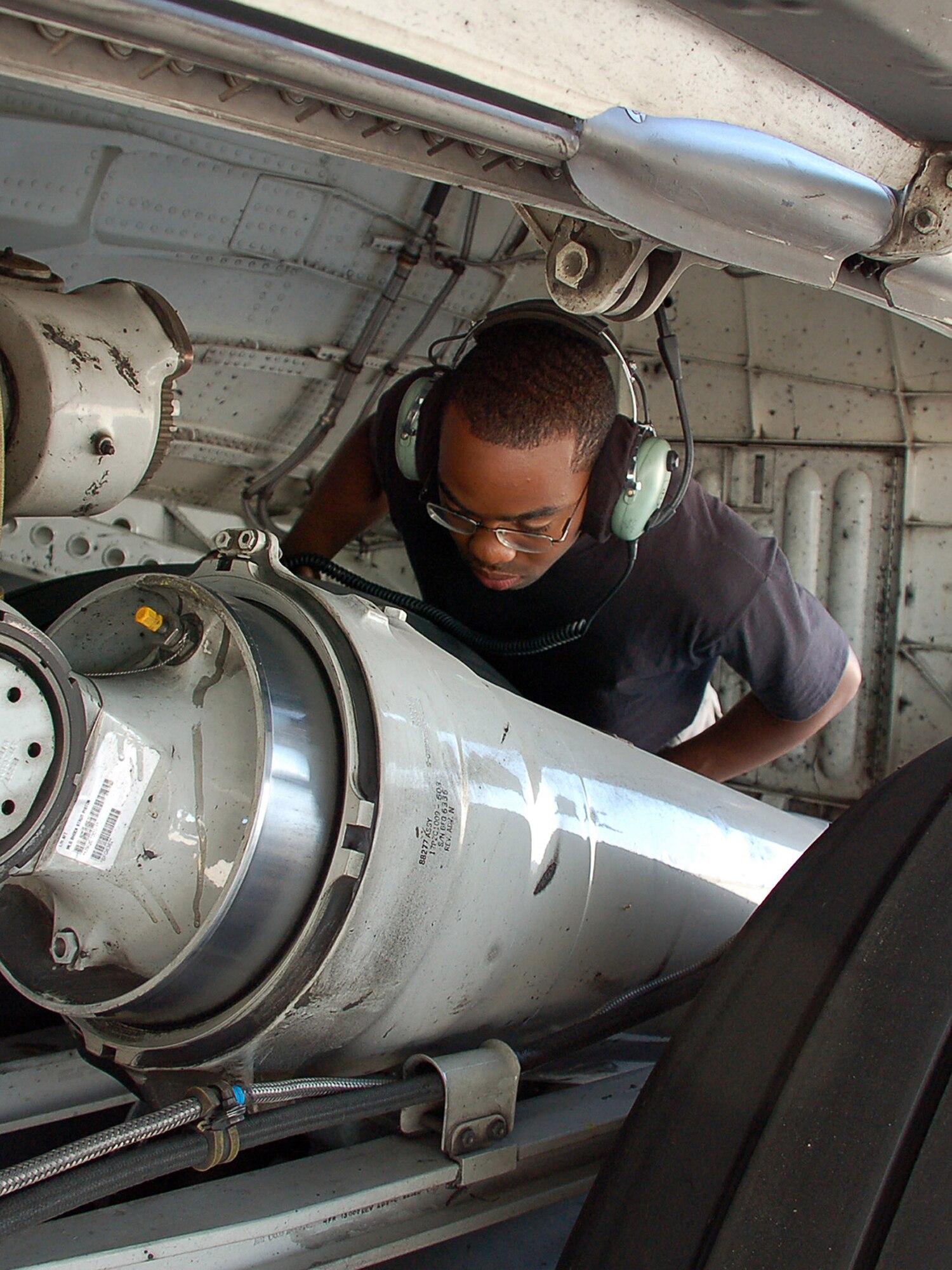 Airman 1st Class Damon McRae checks the main landing gear shock strut for serviceability on a C-17 Globemaster III during a pre-flight inspection.  Airman McRae is a crew chief with the 376th Expeditionary Aircraft Maintenance Squadron.  (Air Force photo/Staff Sgt. Les Waters)