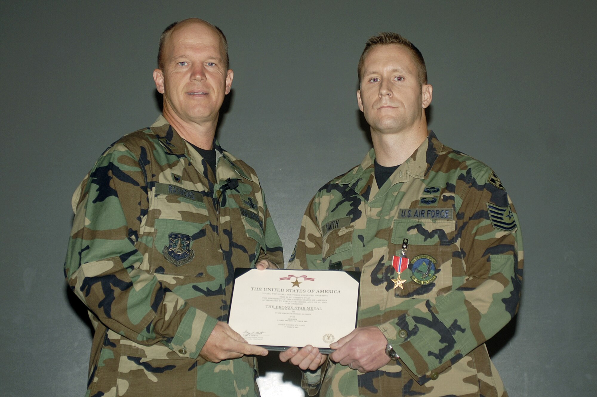 Tech. Sgt. Michael Smith, 13th Air Support Operations Squadron (right) was presented the Bronze Star Medal Aug. 16 by Col. Jay Raymond, 21st Space Wing commander. Sergeant Smith received his award for the work he accomplished as joint terminal attack controller for Army Special Forces in Kandahar, Afghanistan, from April to October 2005. (U.S. Air Force photo by Larry Hulst)