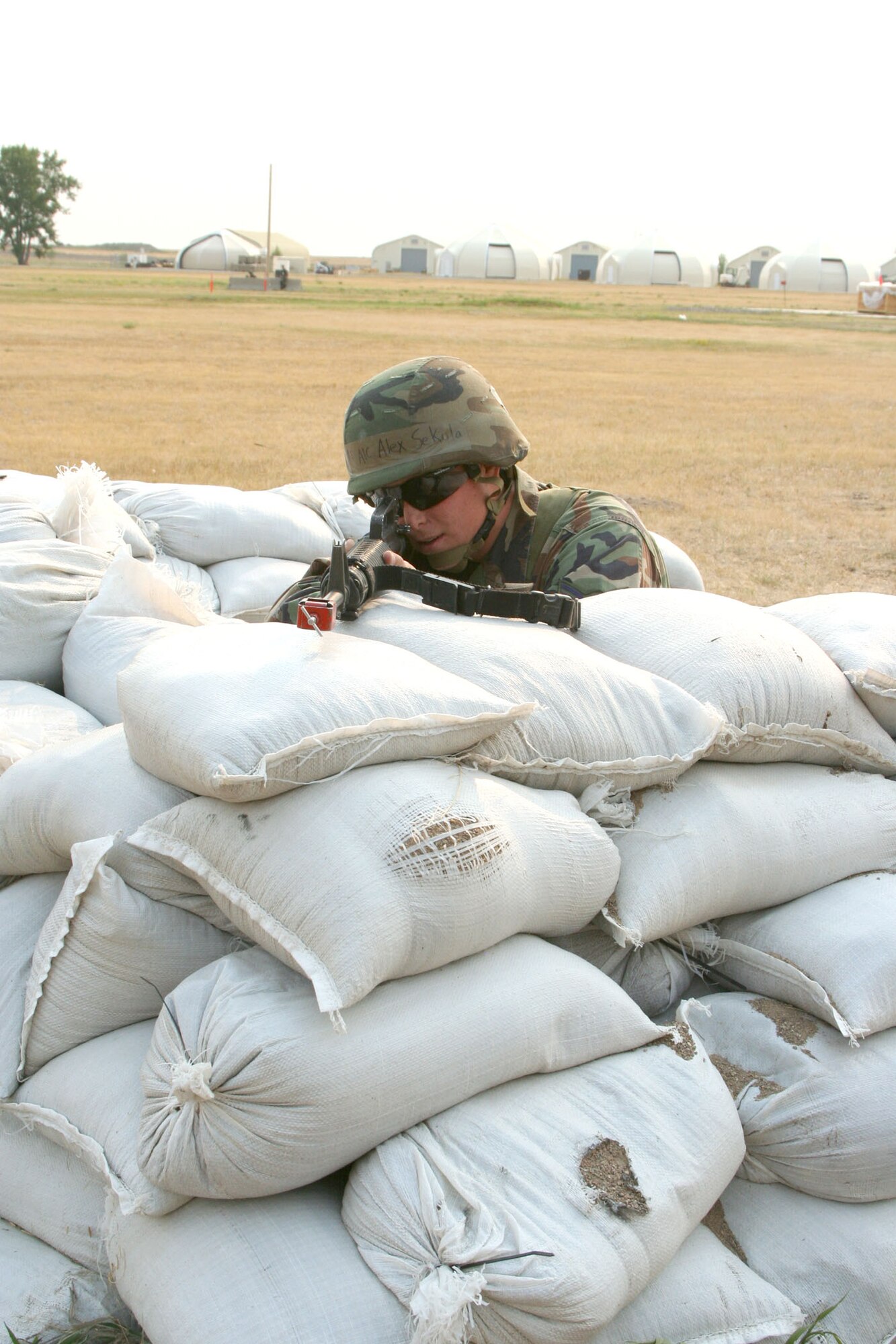 Airman 1st Class Alex Sekula, 341st Civil Engineer Squadron heavy equipment operator, performs perimeter guard duty at a defensive fighting position, or DFP,  during an expeditionary readiness exercise Aug. 13 to 17 at Camp Grizzly on Malmstrom Air Force Base, Mont. The week-long deployment scenario showcased what Airmen might experience while at an area of responsibility. (U.S. Air Force photo/Senior Airman Eydie Sakura).