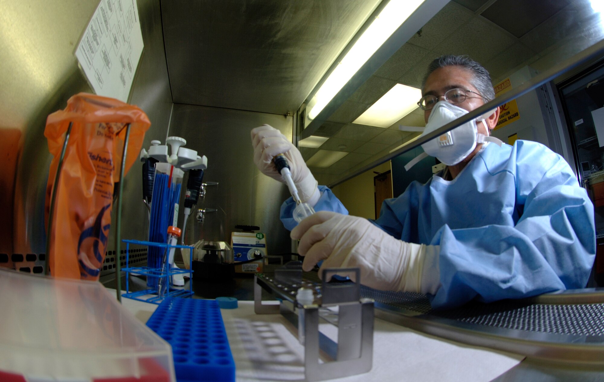 Jesse Salinas, medical technologist with the 59th Laboratory Squadron, extracts DNA from a sample to help determine what strain of flu it is during a Texas Department of Health Services Pandemic flu exercise held August 13-16.   (U.S. Air Force photo by Master Sgt Kimberly A. Yearyean-Siers)