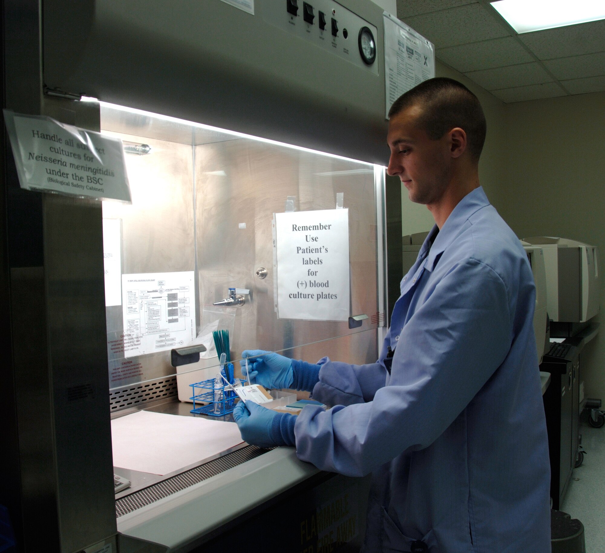 Laboratory technician Airman 1st Class John Marrs, 59th Laboratory Squadron, checks a specimen to determine if it is a strain of flu or another virus during a Texas Department of Health Services Pandemic flu exercise held August 13-16.   (U.S. Air Force photo by Master Sgt Kimberly A. Yearyean-Siers)