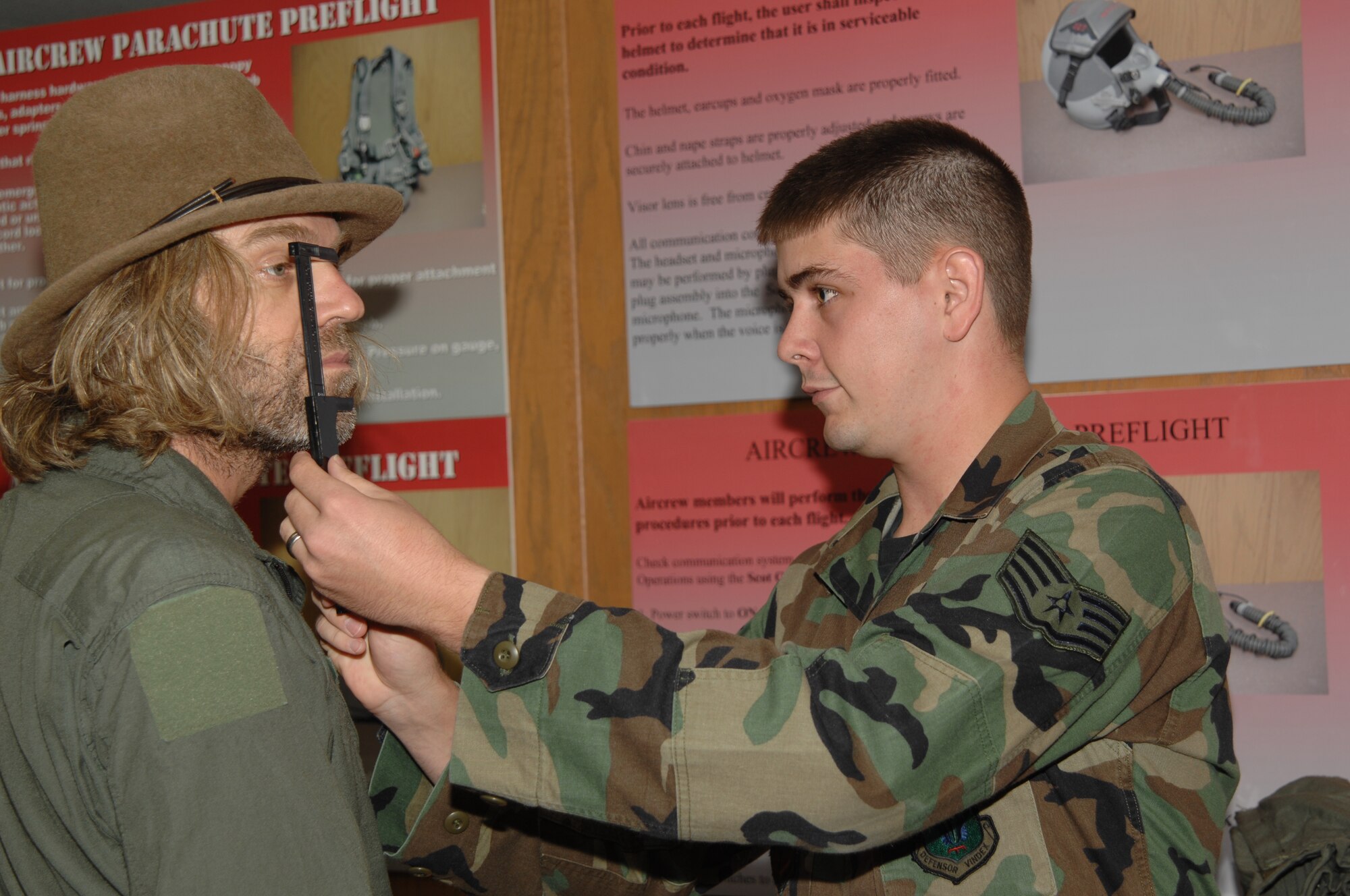 WHITEMAN AIR FORCE BASE, Mo. -- Left to right: Country music performer "Big Kenny" part of the duo that makes up Big & Rich  gets his face measured with a sizing caliber by Staff Sgt. Brian Cockroft, 394th Combat Training Squadron, to ensure his oxygen mask has a proper fit prior to his T-38 incentive flight Aug. 16. The Big & Rich members, who have demonstrated their support for the military at numerous public concerts and events, got a chance to say “Thank you,” to troops and recognize them for their service during a forum in the roll call room. (U.S. Air Force photo/Senior Airman Lauren Padden)   

