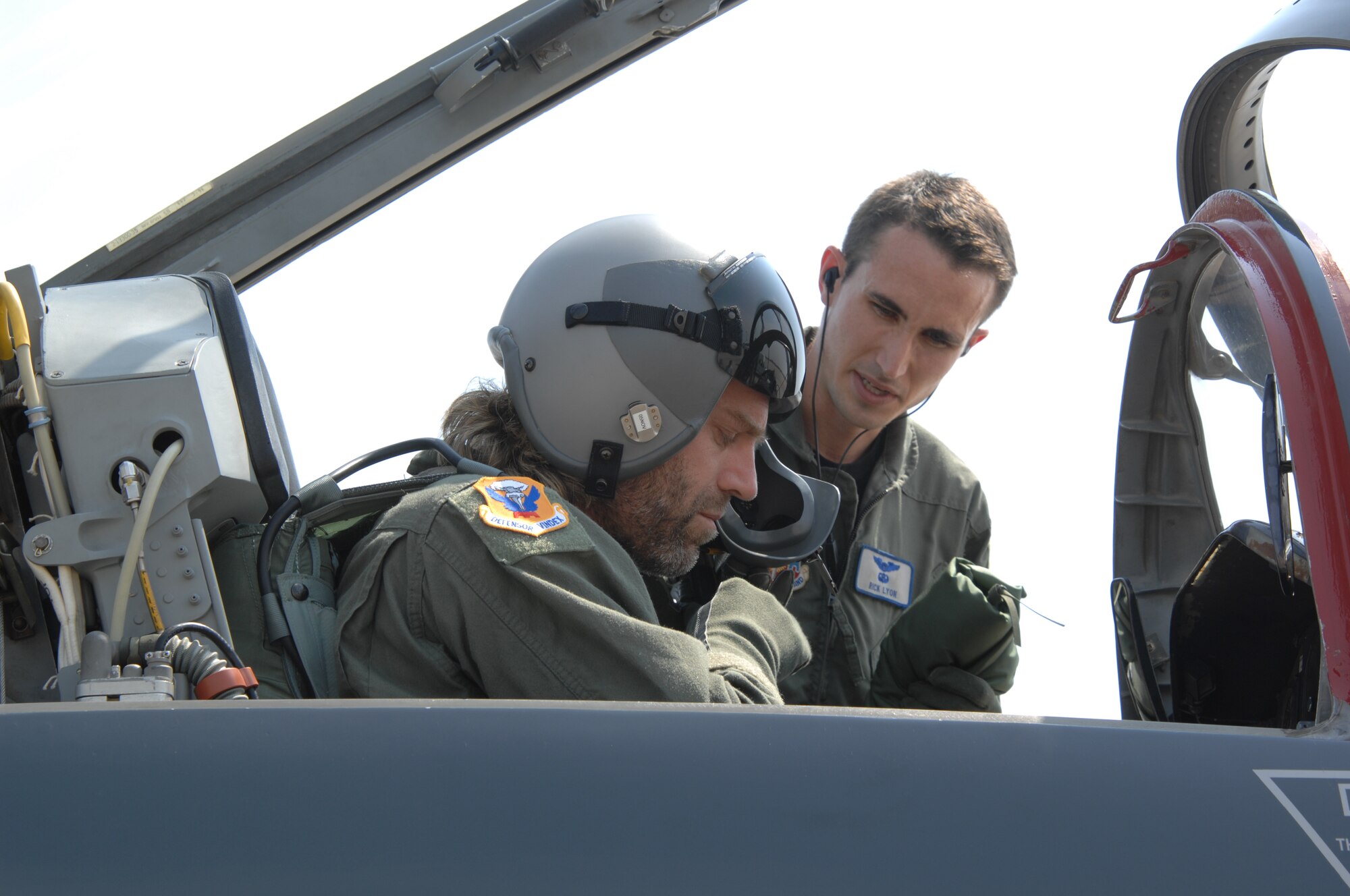 WHITEMAN AIR FORCE BASE, Mo. – Left to right: Country music performer "Big Kenny" part of the duo that makes up Big & Rich gets strapped in a T-38 as he receives a pre-mission briefing from Capt. Richard Lyons, 394th Combat Training Squadron, in preparation for an incentive flight Aug. 16. The Big & Rich members, who have demonstrated their support for the military at numerous public concerts and events, got a chance to say “Thank you,” to troops and recognize them for their service during a forum in the roll call room. (U.S. Air Force photo/Senior Airman Lauren Padden)   