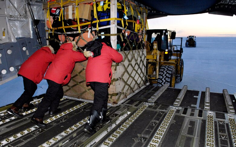 Loadmasters unload a pallet from their C-17 Globemaster III during the winter fly-in for Operation Deep Freeze Aug. 20 at Pegasus Runway in Antarctica. A C-17 and 31 Airmen from McChord Air Force Base, Wash., began the annual winter fly-in augmentation of scientists, support personnel, food and equipment for the U.S. Antarctic Program at McMurdo Station. WinFly is the opening of the first flights to McMurdo Station, which closed for the austral winter in February. (U.S. Air Force photo/Tech. Sgt. Shane A. Cuomo) 

