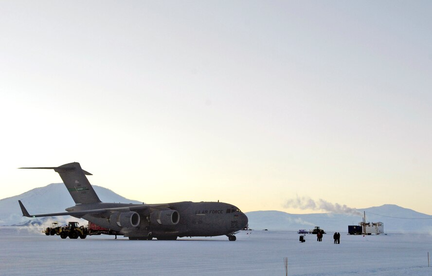 A C-17 Globemaster III is downloaded during the winter fly-in for Operation Deep Freeze Aug. 20 at Pegasus Runway in Antarctica. A C-17 and 31 Airmen from McChord Air Force Base, Wash., began the annual winter fly-in augmentation of scientist, support personnel, food and equipment for the U.S. Antarctic Program at McMurdo Station. WinFly is the opening of the first flights to McMurdo Station, which closed for the austral winter in February. (U.S. Air Force photo/Tech. Sgt. Shane A. Cuomo) 