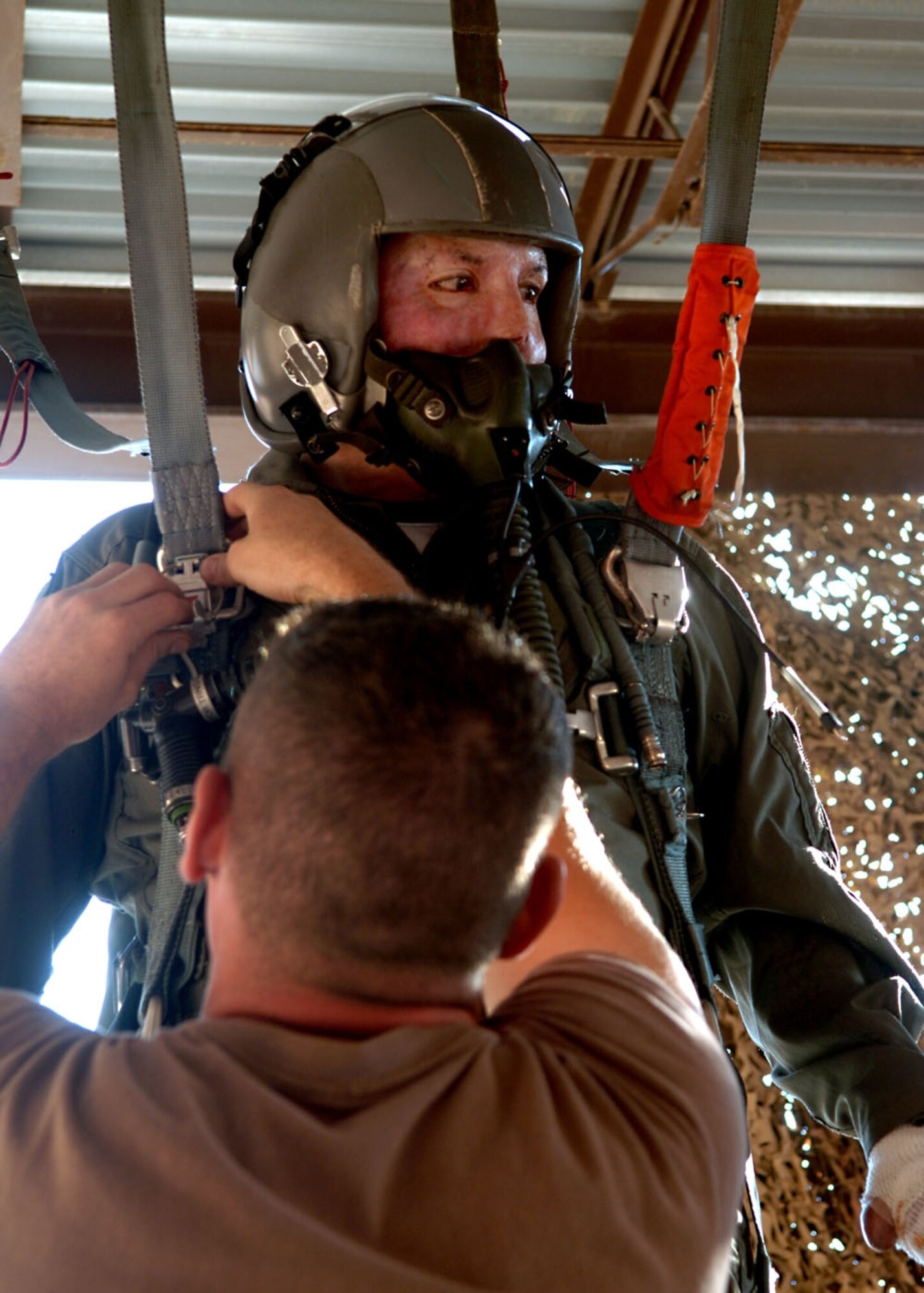 Tech. Sgt. Israel DelToro does the hanging portion of his parachute training before getting a flight in a T-38 Talon. Sergeant DelToro is a tactical air control party Airman who talked at Holloman's Warrior Call Aug. 17 about the events that gave him third-degree burns over more than 80 percent of his body. (U.S. Air Force photo/Airman 1st Class Tiffany Trojca)