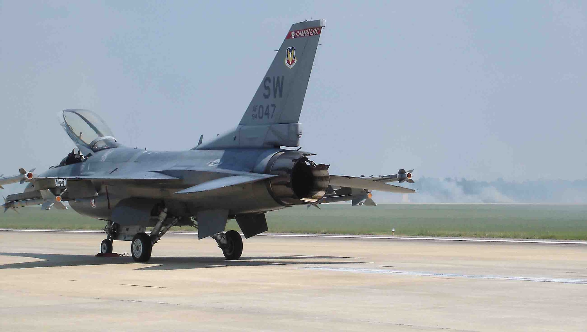 SHAW AIR FORCE BASE, S.C. -- Capt. Brian Crum, 77th Fighter Squadron F-16CJ pilot, safely landed his damaged aircraft three minutes after takeoff Sept. 21, 2006. His aircraft's jet engine was on fire and during takeoff the engine fire ignited the flightline field. With the assistance of his flight lead, Capt. Julie Moore, the pilots were able to save the aircraft and more importantly they safely avoided populated areas. The pilots received Airman Medals for their successful efforts. (U.S. Air Force photo/Master Sgt. Ross Grimes)                              