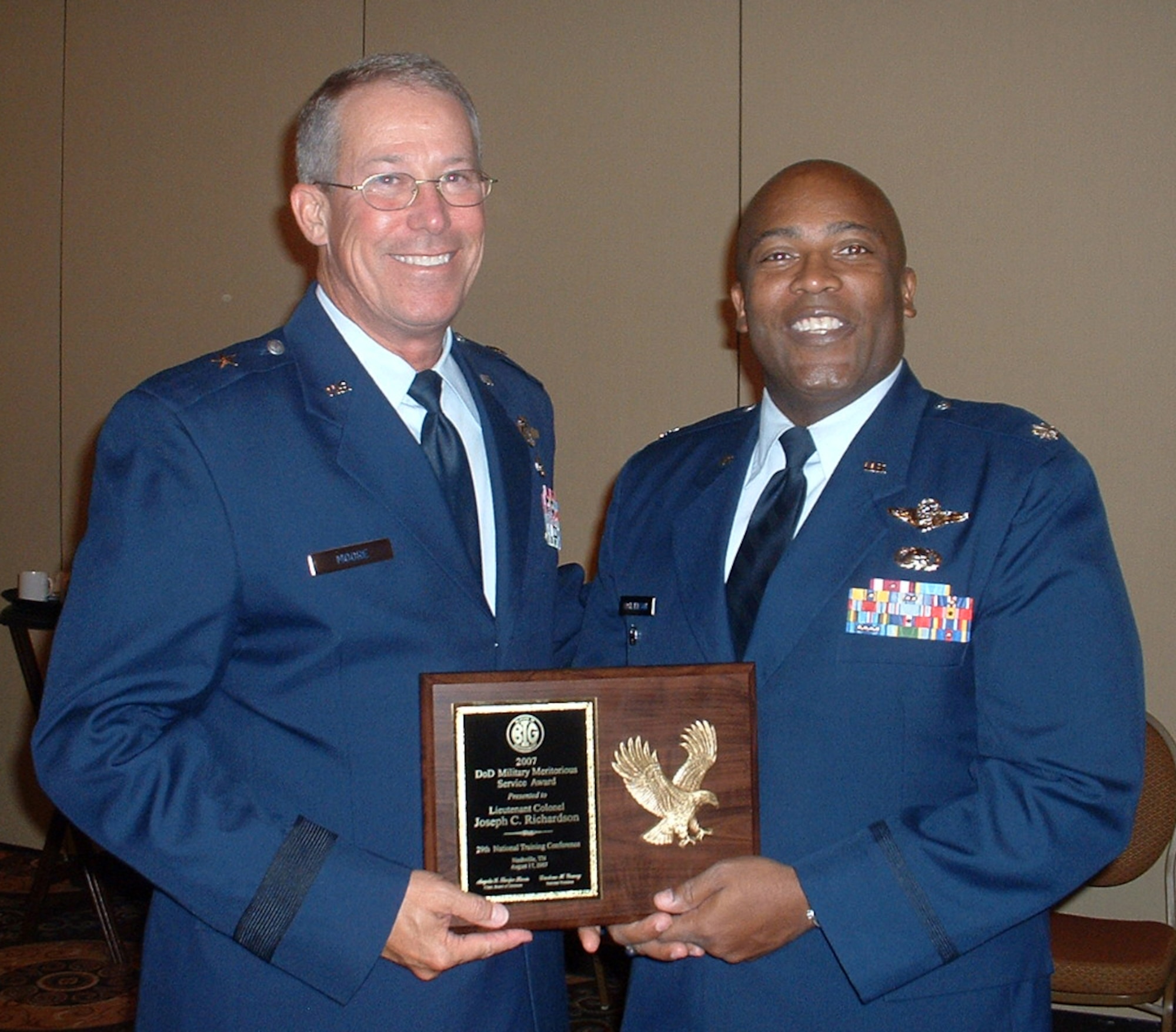 Lt. Col. Jospeh Richardson (right) accepts the 2007 Blacks in Government Meritorious Service Award, Aug. 17 at a ceremony in Nashville, Tenn. at the Gaylord Opryland Hotel from the 116th Air COntrol Wing commander, Brig. Gen. Tom Moore. The award is given annually to a military member or Department of Defense civilian employee who has distinguished themselves through significant contributions to their service, the advancement of African Americans and to our nation. 

