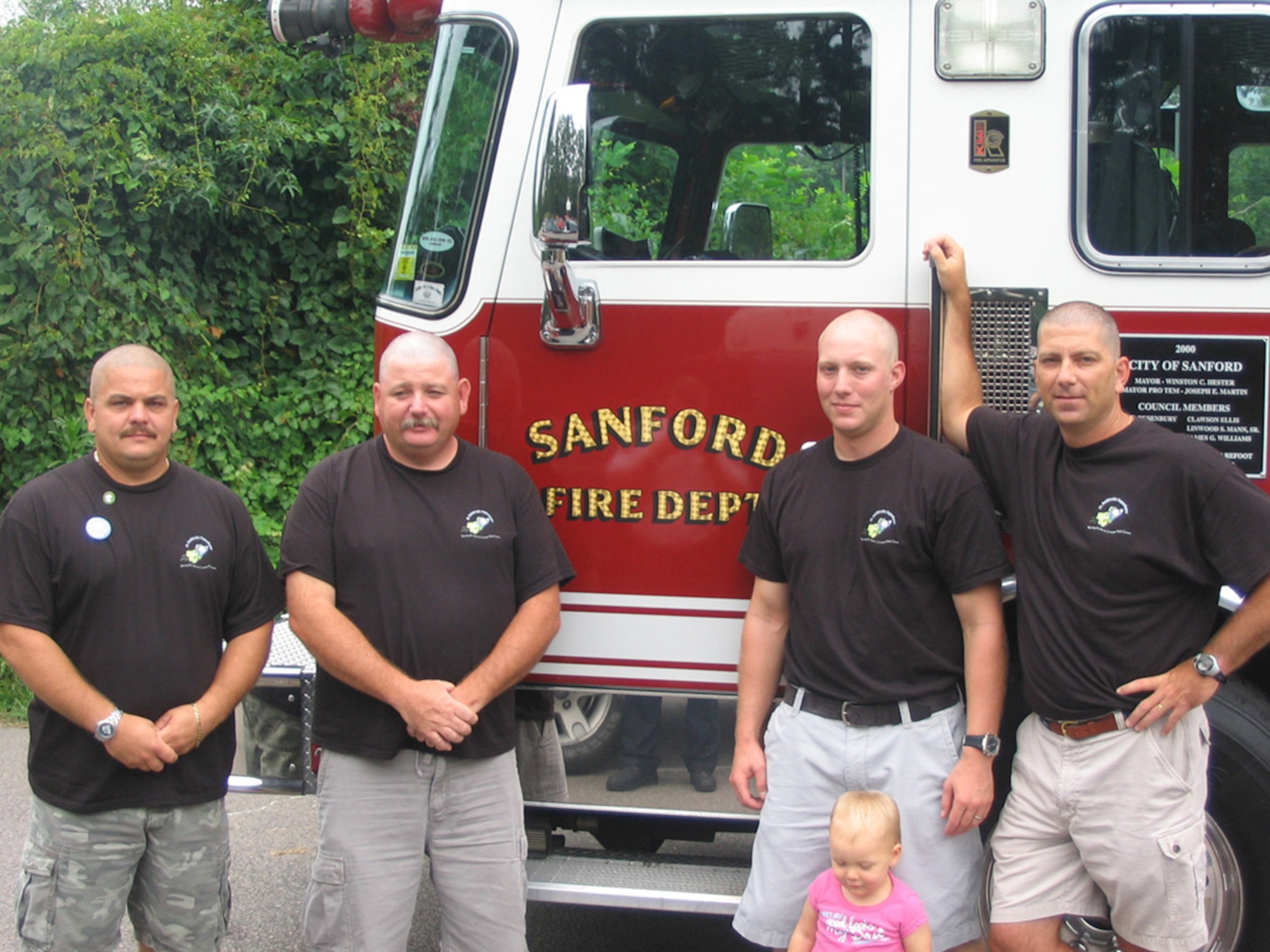 SEYMOUR JOHNSON AIR FORCE BASE, N.C. -- Senior Master Sgt. Donald Knuth (far right), a Reservist with 916th Air Refueling Wing and full-time Sanford firefighter, shows off his new haircut with other members of the Sanford Fire Dept. Sgt. Knuth, a deputy fire chief with the Tarheel Reserve wing, shaved his head to help benefit the St. Baldrick's Foundation, a charity supporting children's cancer research. Sgt. Knuth helped raise more than $5,000 for the charity.