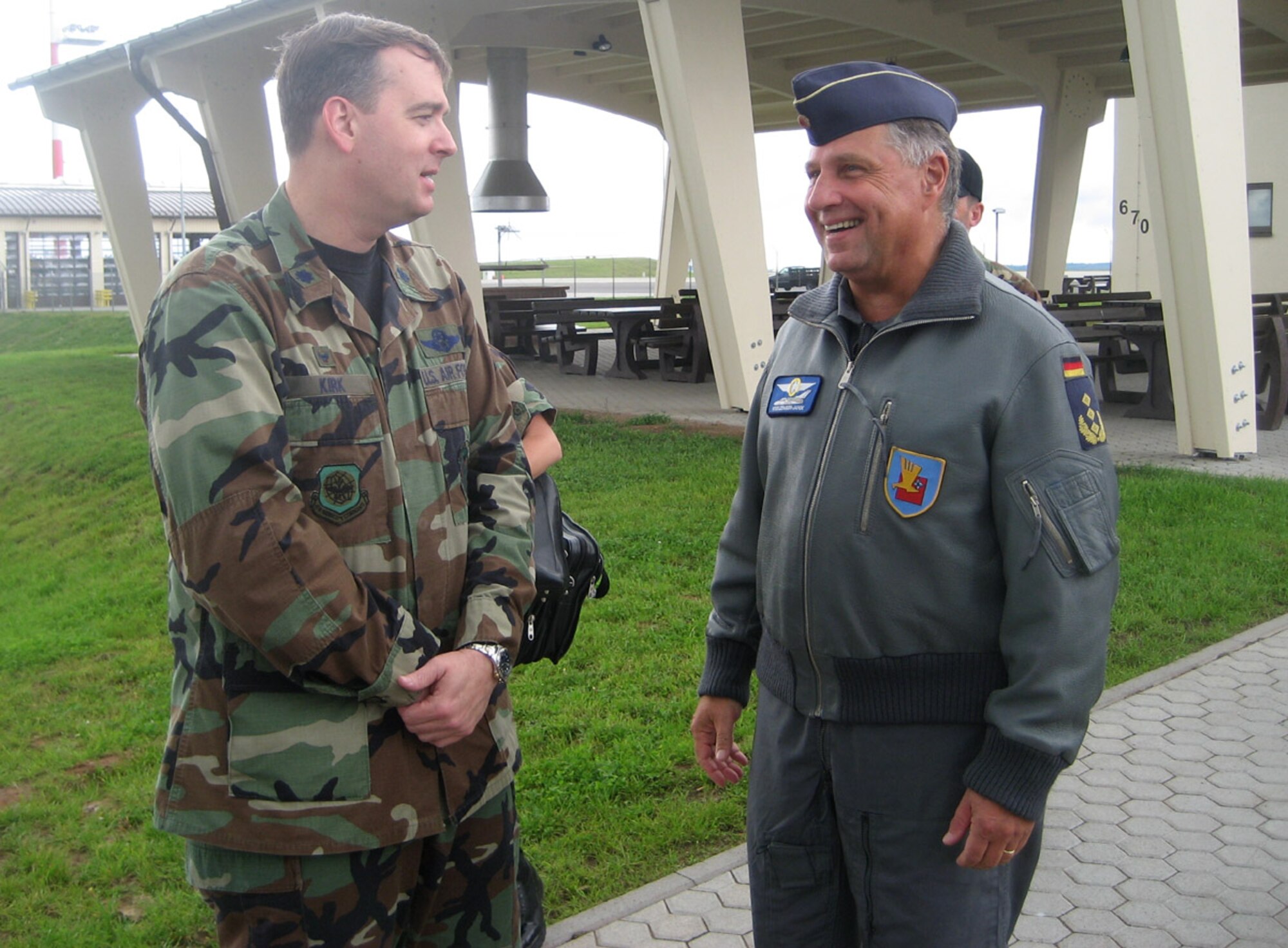 SPANGDAHLEM AIR BASE, Germany – Lt. Col. James Kirk, 726th Air Mobility Squadron commander, and Lt. Gen. Aarne Kreuzinger-Janik, Commander German Air Force Command, bid farewells after the colonel provided a 726th AMS mission brief to the general, as well as Lt. Gen. Robert Bishop, 3rd Air Force commander, during a visit here Aug. 20. The purpose of the general’s visit was for 3rd Air Force orientation and open discussion on interoperability and bolster NATO partnership. (U.S. Air Force photo/Staff Sgt. Andrea Knudson)
