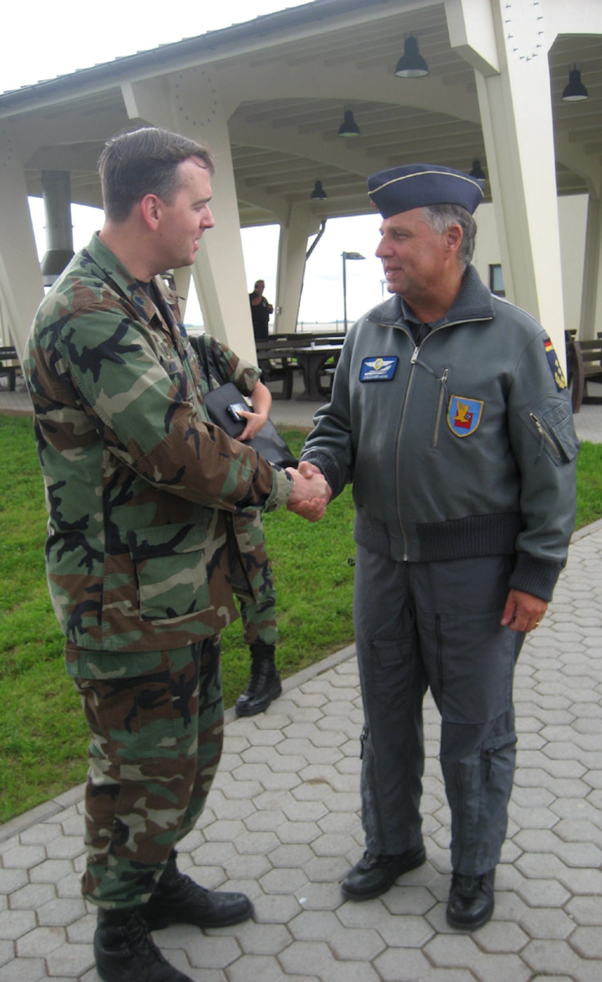SPANGDAHLEM AIR BASE, Germany – Lt. Gen. Aarne Kreuzinger-Janik, Commander German Air Force Command, congratulates Lt. Col. James Kirk, 726th Air Mobility Squadron commander, on his recent selection to colonel. General Kreuzinger-Janik visited Spangdahlem Aug. 20. The purpose of the general’s visit was for 3rd Air Force orientation and open discussion on interoperability and bolster NATO partnership. (U.S. Air Force photo/Staff Sgt. Andrea Knudson)
