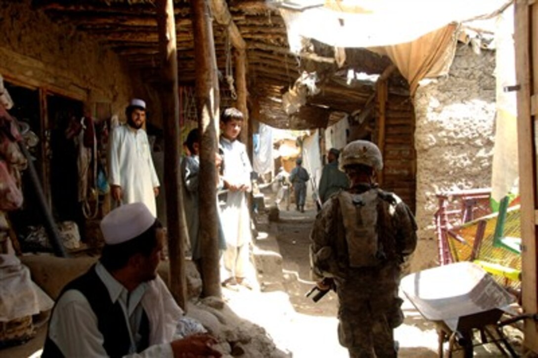 U.S. Army Staff Sgt. Ronny Burt, from the 3rd Battalion, 172nd Mountain Infantry Regiment, Vermont National Guard, conducts a dismounted patrol with Afghan National Police officers in the Kapisa Province of Afghanistan, Aug. 16, 2007. 