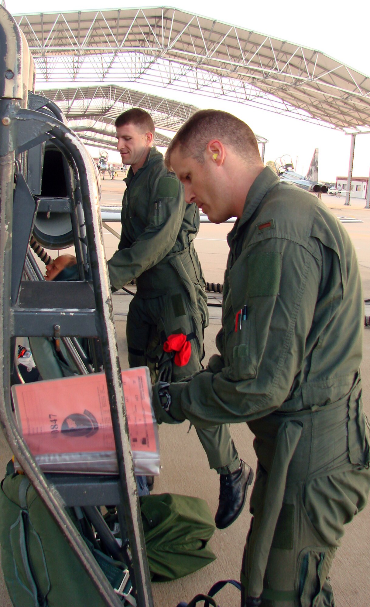 2nd Lt. Clay Bird, Introduction to Fighter Fundamentals student, and Capt. Nathan Thompson, 3rd Fighter Training Squadron flight commander, prepare their AT-38 Wednesday for the first sortie of the inaugural IFF class at Vance.  Lieutenant Bird said he was nervous but excited about taking the first “go” of the day. (Air Force photo by Capt. Tony Wickman)