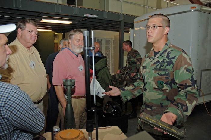Airman 1st Class Jonathan Baxley, 437th Civil Engineer Squadron explosive ordnance device specialist, explains to a group of retirees why C5 explosive would be used and how it would be used to detonate Improvised Explosive Devices on base Wednesday.