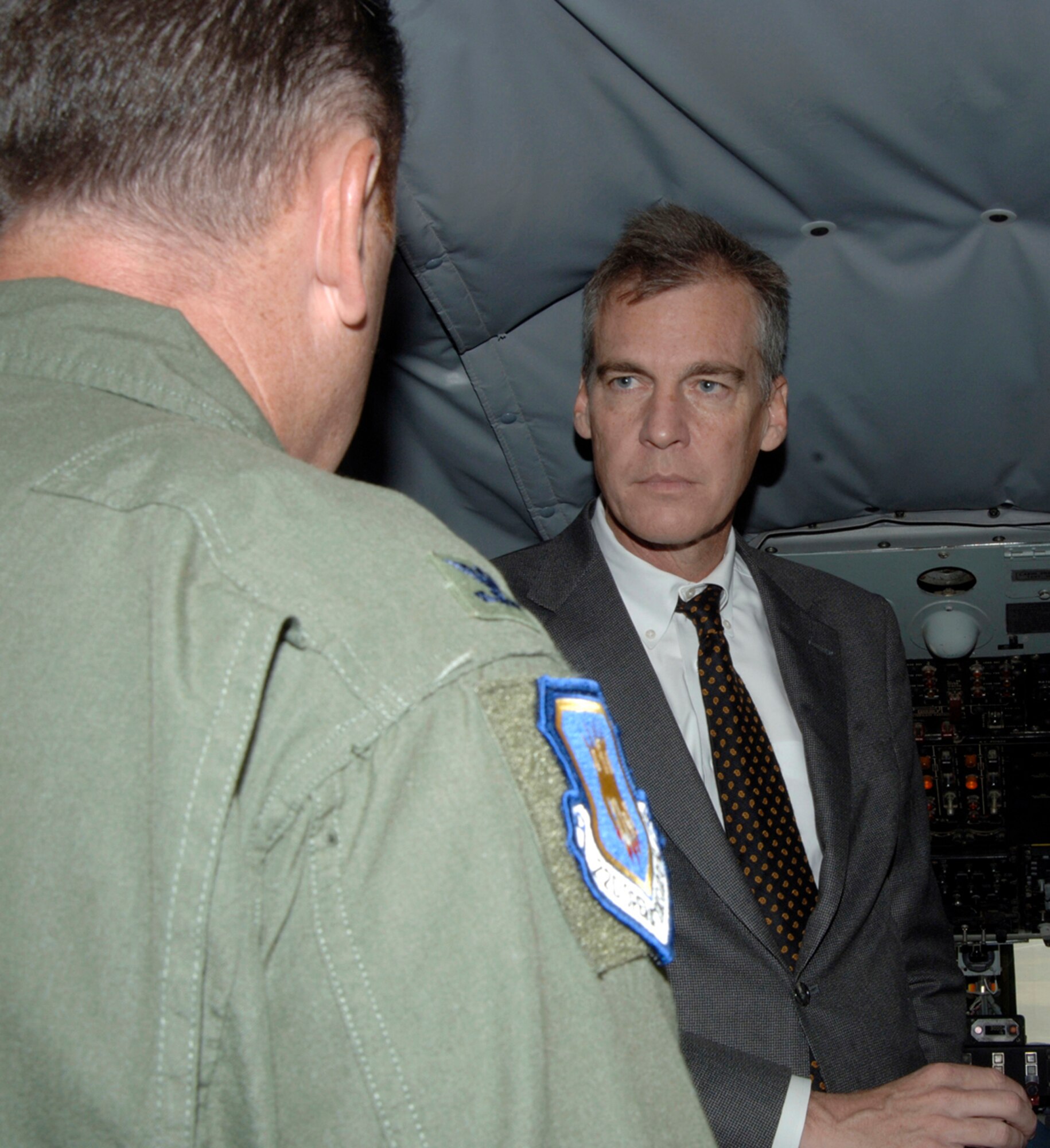 MCCONNELL AIR FORCE BASE, Kan. -- Col. Stuart Shaw, left, 22nd Operations Group commander, provides Lt. Gov. Mark Parkinson with a brief history of the KC-135 Stratotanker while aboard one of the aircraft during a base tour here Aug. 20. (Photo by Airman Justin Shelton) 