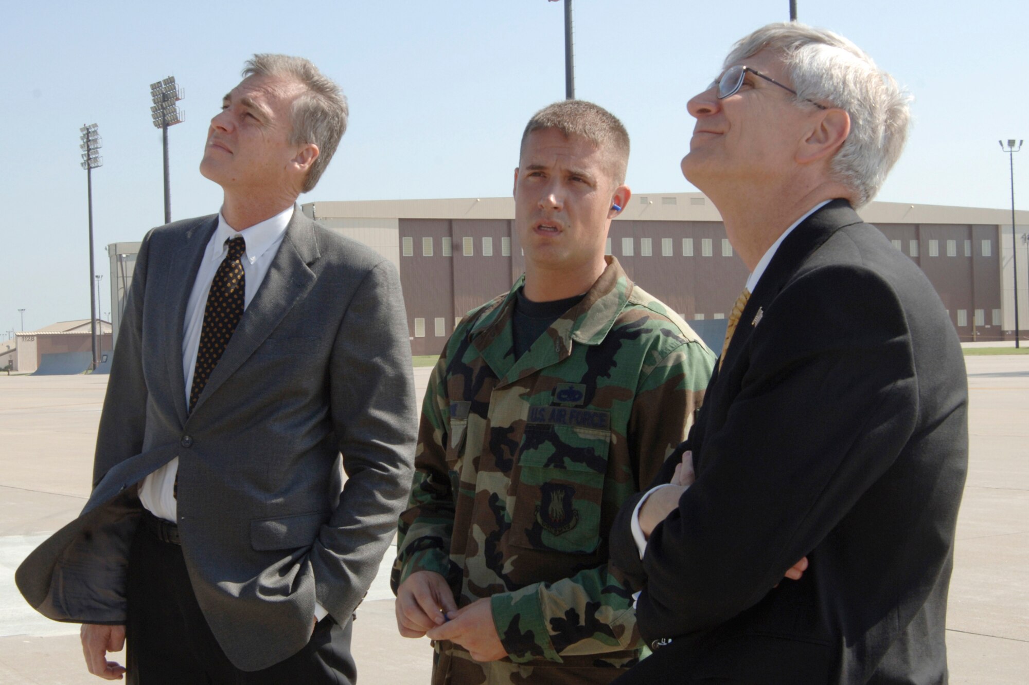 MCCONNELL AIR FORCE BASE, Kan. -- Tech. Sgt. Jason Levine, 22nd Aircraft Maintenance Squadron, describes a KC-135 Stratotanker’s capabilities to Mark Parkinson, left, Kansas lieutenant governor, and John Armbrust, right, executive director of the Kansas governor’s Strategic Military Planning Commission, during a base tour here Aug. 20. (Photo by Airman Justin Shelton) 