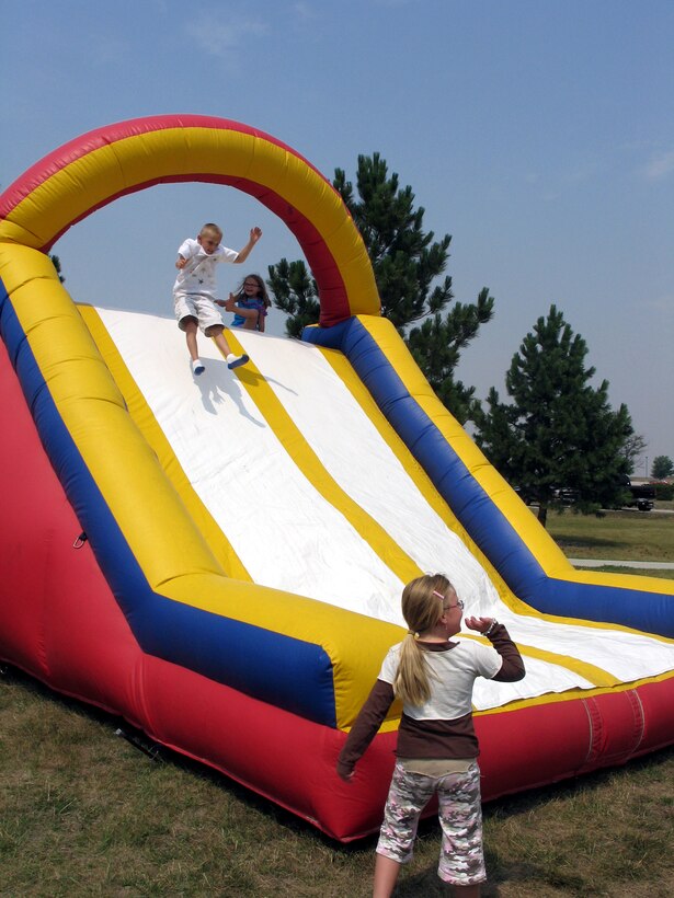 Children seemed unable to resist the temptation of an inflatable slide that combined the bounce of a jumpy castle and the speed of the slope during the Ellsworth base picnic Aug. 20. This annual family-friendly event was sponsored primarily by local businesses as a way to say thank you to active-duty Airmen, retirees, Department of Defense civilians and families for their hard work, dedication and sacrifices. The picnic featured free food, athletic competitions, tournaments and children-specific activities from arts and crafts to jumping castles. (U.S. Air Force photo/Staff Sgt. Shanda De Anda)