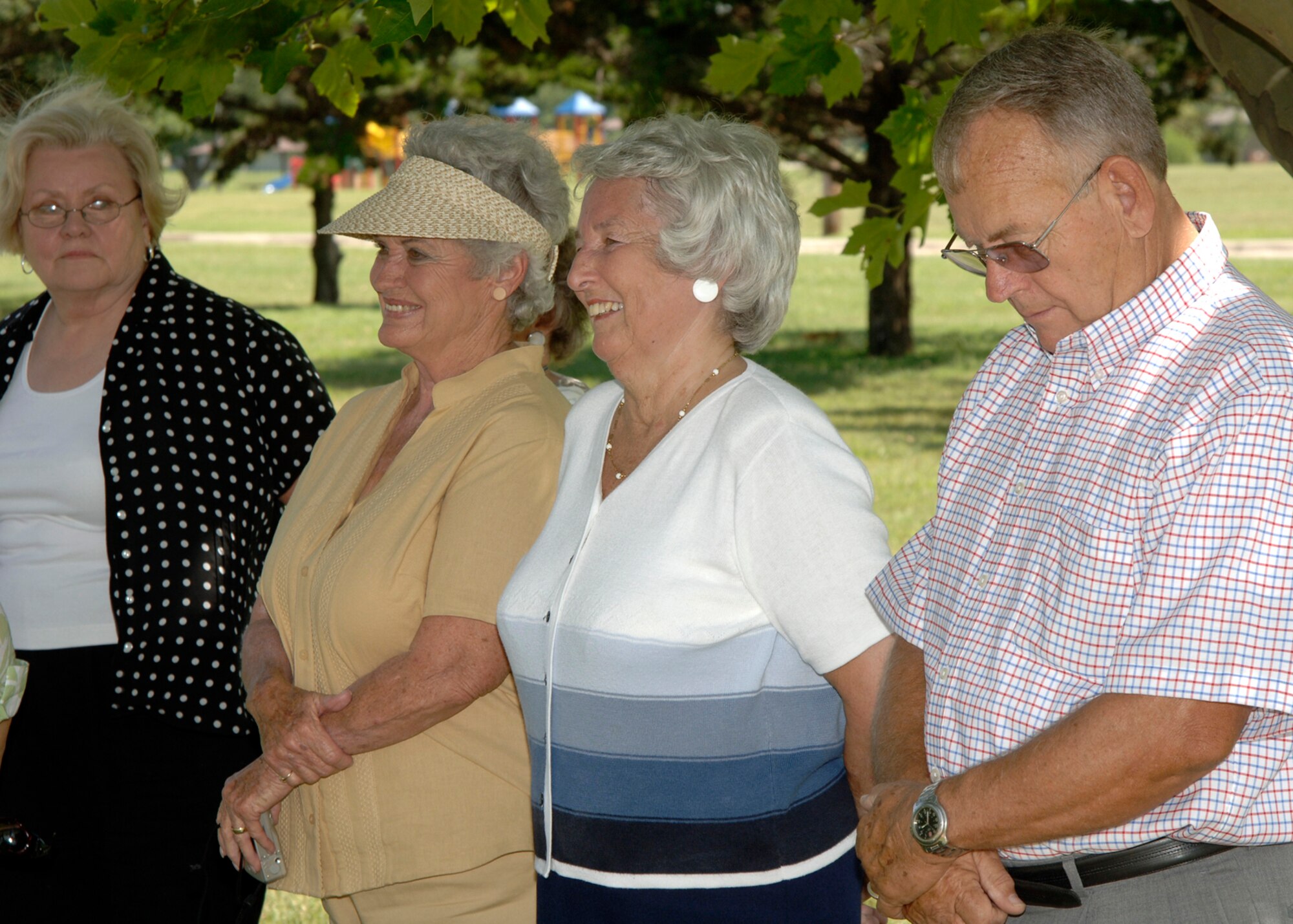 MCCONELL AIR FORCE BASE, Kan. -- Family members of the late Maj. Glenn Walsh gather around the memorial stone dedicated on his behalf Aug 10 at the memorial walk. More than 24 of Major Walsh’s family members attended the memorial service. Major Walsh’s family received a special memorial stone for his years of dedication and service to McConnell and the Air Force. (photo by Airman First Class Laura Suttles)