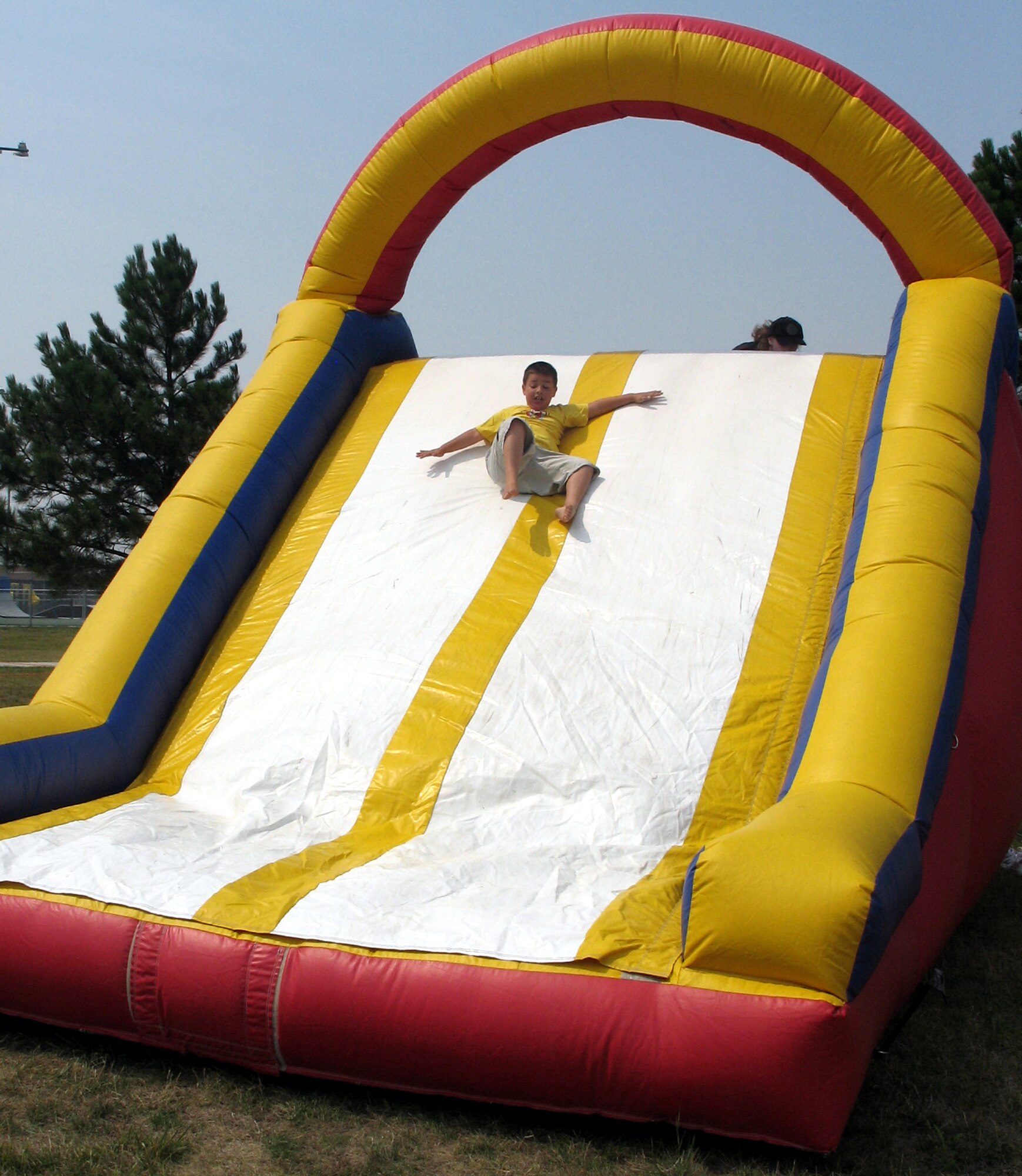 Children seemed unable to resist the temptation of an inflatable slide that combined the bounce of a jumpy castle and the speed of the slope during the Ellsworth base picnic Aug. 20. This annual family-friendly event was sponsored primarily by local businesses as a way to say thank you to active-duty Airmen, retirees, Department of Defense civilians and families for their hard work, dedication and sacrifices. The picnic featured free food, athletic competitions, tournaments and children-specific activities from arts and crafts to jumping castles. (U.S. Air Force photo/Staff Sgt. Shanda De Anda)