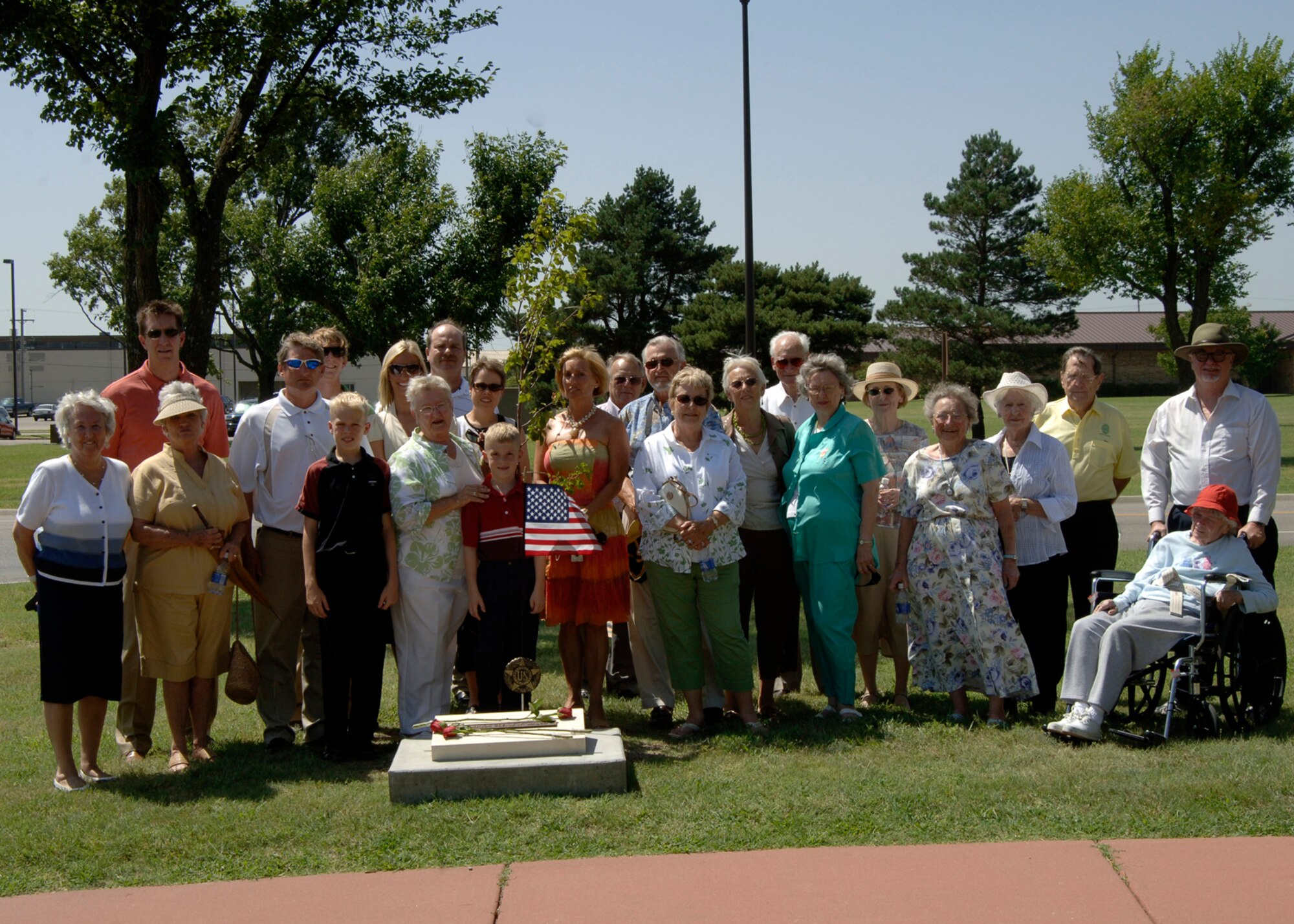 MCCONELL AIR FORCE BASE, Kan. -- Family members of the late Maj. Glenn Walsh gather around the memorial stone dedicated on his behalf Aug 10 at the memorial walk. More than 24 of Major Walsh’s family members attended the memorial service. Major Walsh’s family received a special memorial stone for his years of dedication and service to McConnell and the Air Force. (photo by Airman First Class Laura Suttles)