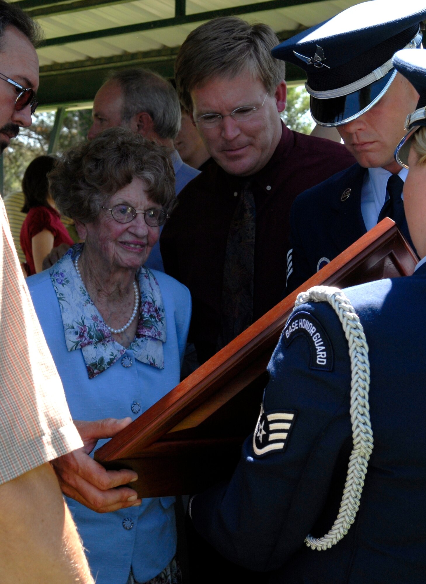 Altus Air Force Base "Blue Knights" Honor Guard members present Lt. Col. Jim Ayres mother with a shadow box containing a folded flag, Colonel Ayres decorations, name tag and Air Force insignia. (U.S. Air Force photo/Senior Airman Joshua DeMotts) 