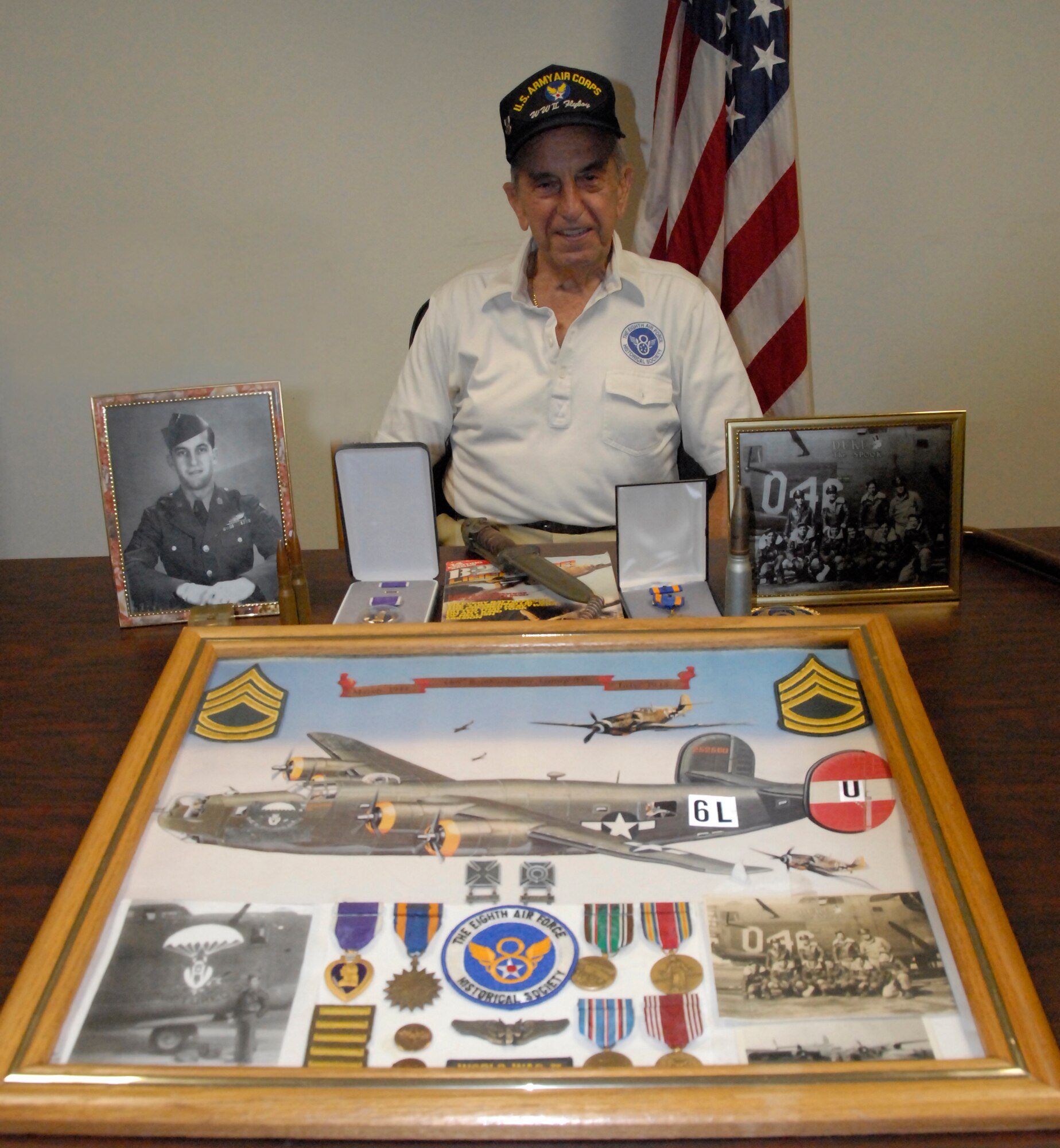 Hanscom Air Force Base, Mass. -- World War II Tech. Sgt. Carl Mula poses with his memorabilia from his time in service with the Army Air Corps in Hanscom’s building 1305. Sergeant Mula is a Purple Heart recipient. (U.S. Air Force photo by Senior Airman Clinton Atkins)