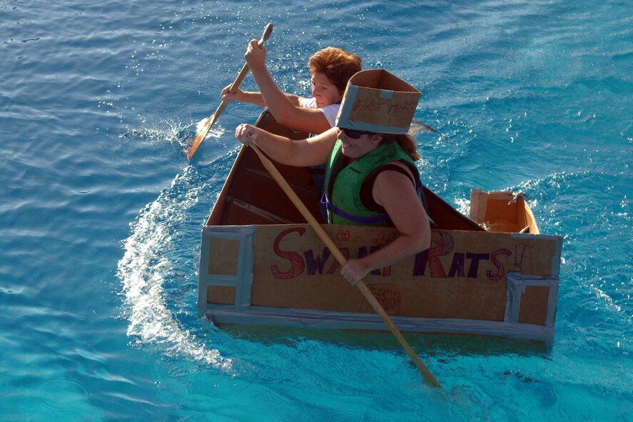 DYESS AIR FORCE BASE, Texas -- The Swamp Rats paddle for victory at the pase pool during the annual Build-a-Boat contest Aug 21. Even on the verge of sinking, the swamp rats still pulled out the victory. (U.S. Air Force Photo by Airman First Class Micheal S. Breaux)