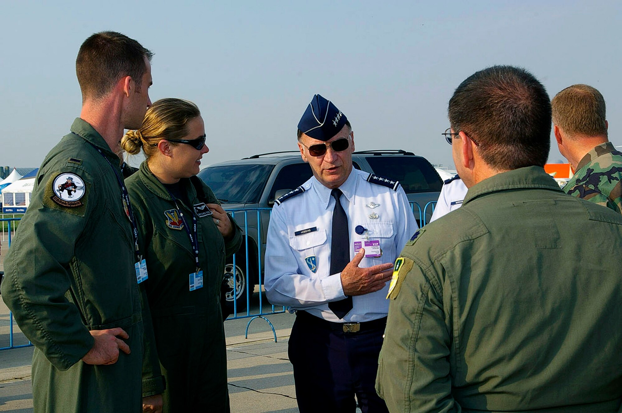 1st Lt. Mike Middents (from left), Capt. Gretchen Dues and Lt. Col. Jeff Marcotte (far right) talk with Gen. William T. Hobbins during the opening day of the Moscow International Air Show Aug. 21 at Ramenskoye Airfield in Zhukovsky, Russia. The air show runs through Aug. 26 and includes Department of Defense participation of static displays and aerial flight demonstrations. General Hobbins is commander of U.S. Air Forces in Europe. The Airmen are from the 2nd Bomb Wing at Barksdale Air Force Base, La. (U.S. Air Force photo/Karen Abeyasekere)
