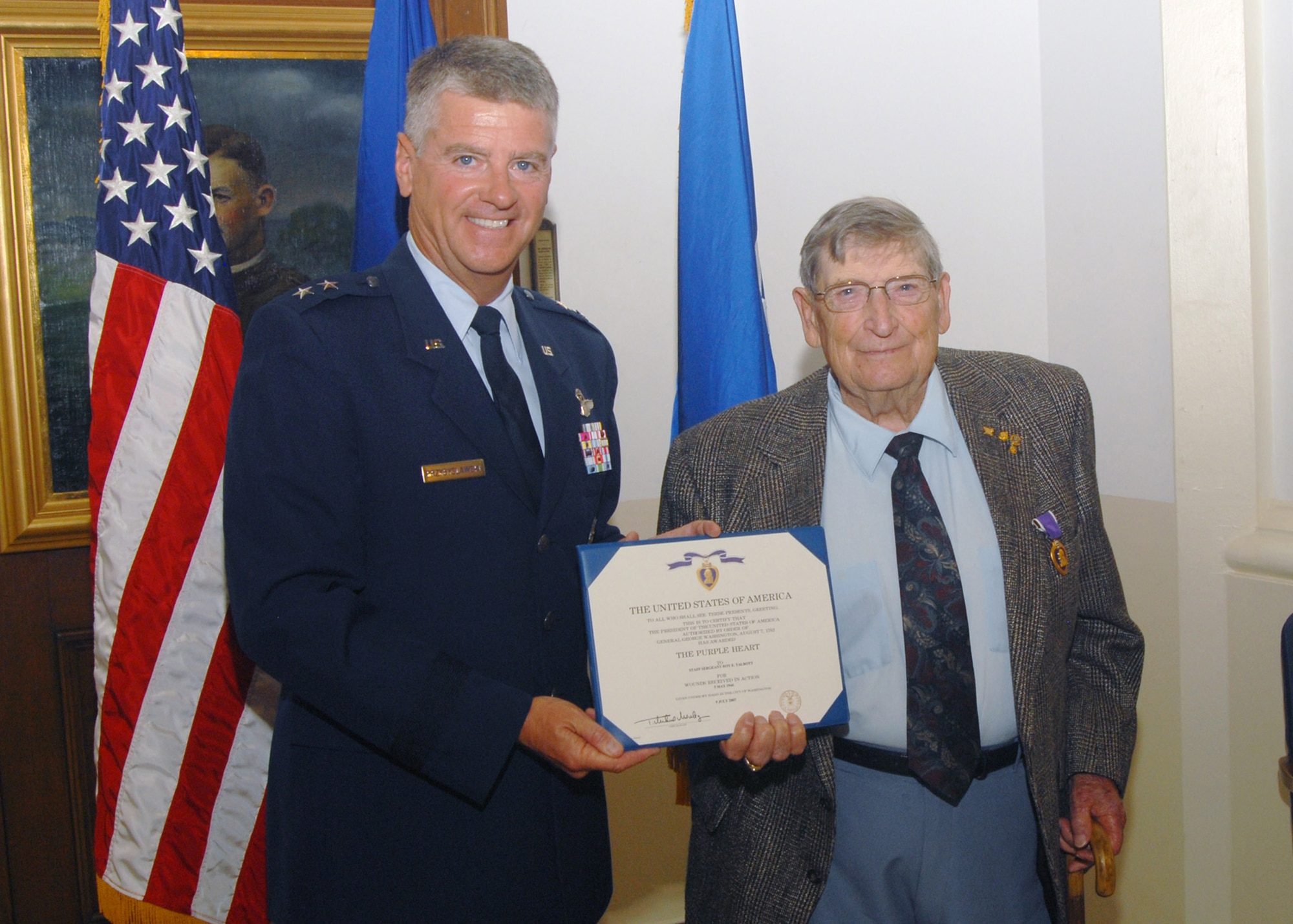 Maj. Gen. Anthony Przybyslawski stands with Roy E. Talbott after presenting him with a Purple Heart Aug. 21 at Randolph Air Force Base, Texas. Mr. Talbott served as a B-24 gunner with the 72nd Bomb Squadron of the 13th Air Force's 5th Bomb Group, and received the Purple Heart for injuries he received in an attack by Japanese fighter planes in the Pacific Theater during World War II. The general is the Air Force Personnel Center commander. (U.S. Air Force photo/Steve White)
