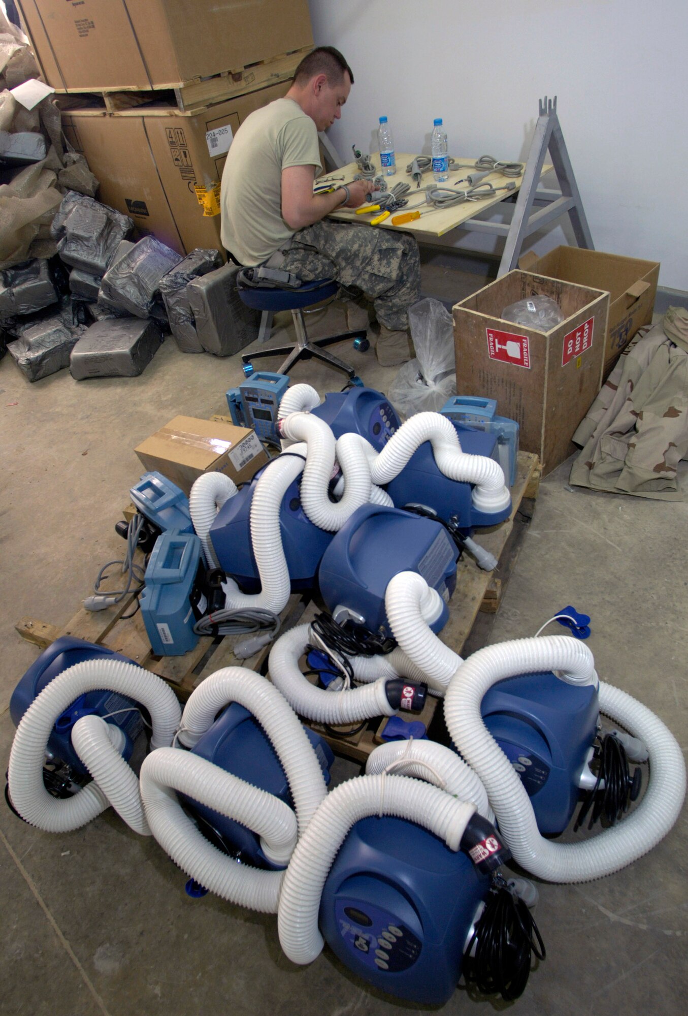 Tech. Sgt. Curtis Miller assembles medical equipment in a warehouse Aug 17.  Once assembled, the equipment will be transported across the street, to the newly built $6.5 million, 50-bed hospital on the Afghan National Army's Hero Camp, located just outside Kandahar Airfield in southern Afghanistan. Sergeant Miller is a medical logistics technician and Afghan National Army mentor. He is assigned to the Combined Security Transition Command-Afghanistan headquartered on Camp Eggers, Kabul, Afghanistan. (U.S. Air Force photo/Master Sgt. Jim Varhegyi) 
