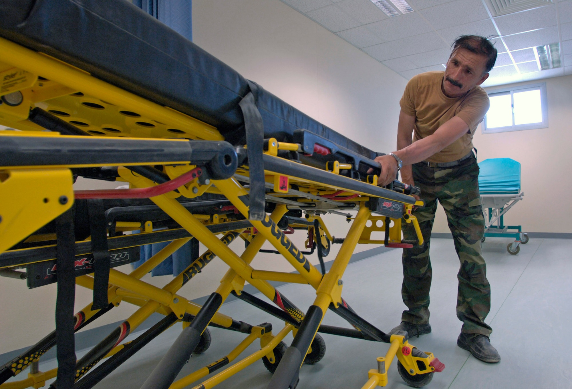 Afghan National Army Maj. Abdul Ghafar inspects an ambulance stretcher Aug. 17 in the newly built $6.5 million, 50-bed ANA hospital at the ANA's Hero Camp, just outside of Kandahar Airfield in southern Afghanistan. Major Ghafar is the ANA's 205th Hero Corps warehouse commander. He is also in charge of all logistical support for the 205th. (U.S. Air Force photo/Master Sgt. Jim Varhegyi)