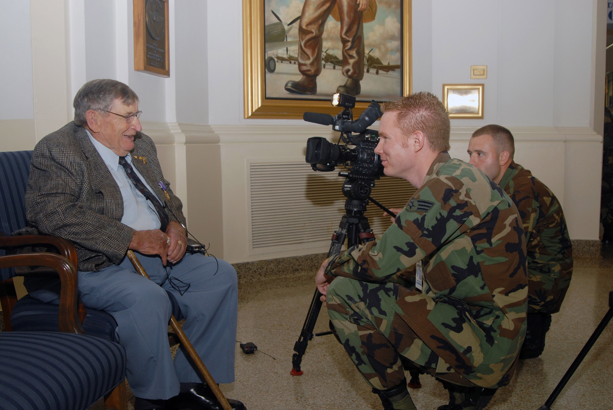 Roy E. Talbott is interviewed by Senior Airman Grant Hagman (forefront) and Airman 1st Class Robbie Arp of the Air Force News Agency Aug. 21 at Randolph Air Force Base, Texas. Mr. Talbott is a veteran who served as a B-24 gunner with the 72nd Bomb Squadron of the 13th Air Force's 5th Bomb Group. He received the Purple Heart for injuries he received in an attack by Japanese fighter planes in the Pacific Theater during World War II. (U.S. Air Force photo/Steve White)