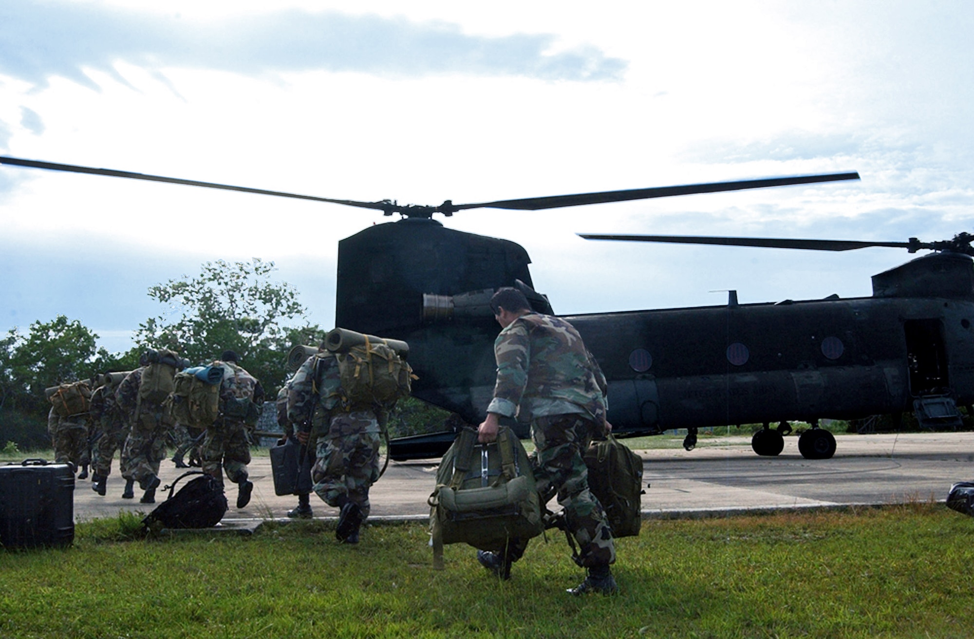 Members of the Belizean Defense Force board a U.S. Army CH-47 Chinook helicopter in Belize City, Belize, to be transported to other areas within the country following the landfall of Hurricane Dean here Aug. 21.  The Chinook, assigned to the 1st Battalion, 228th Aviation Regiment at Soto Cano Air Base, Honduras, transported approximately 20 U.S. Soldiers and Airmen here as part of an initial assessment team following the hurricane. (U.S. Air Force photo/Tech. Sgt. Sonny Cohrs)