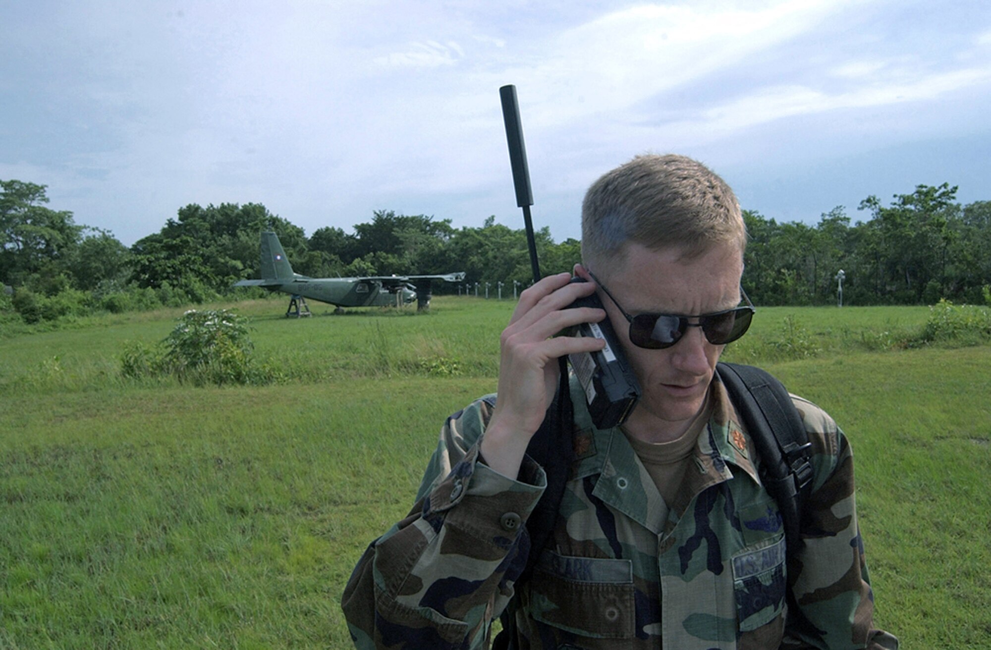 Maj. Jason Clark uses a satellite phone to contact Joint Task Force-Bravo headquarters at Soto Cano Air Base, Honduras, shortly after touching down at Belize City, Belize. Approximately 20 Soldiers and Airman from Soto Cano Air Base, Honduras, deployed here as part of an initial assessment team following Hurricane Dean Aug 21. Major Clark is the operations officer for the tactical operations center.  (U.S. Air Force photo/Tech. Sgt. Sonny Cohrs) 