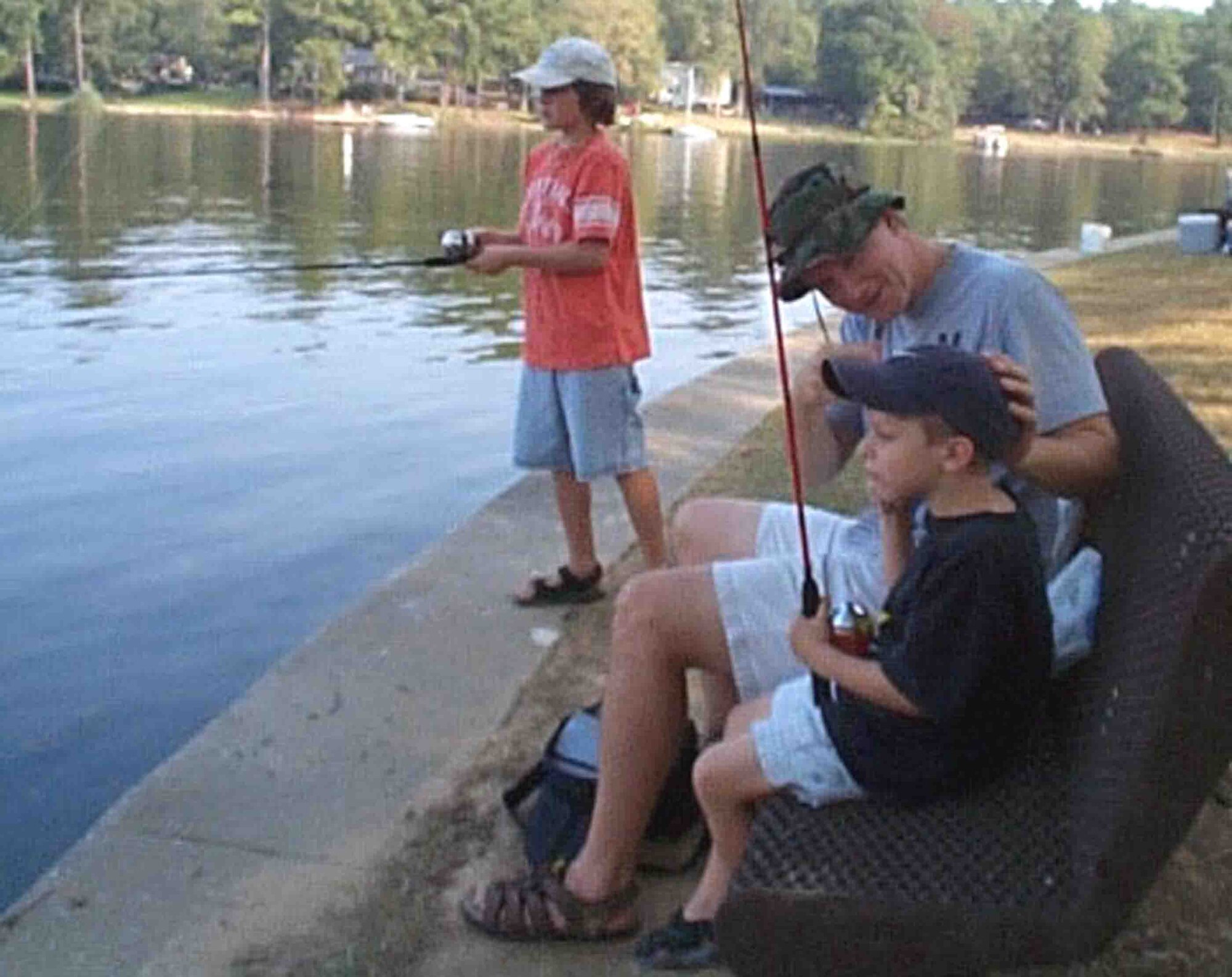 LAKE WATEREE, S.C. -- Capt. Michael Gaston, 20th Operations Support Squadron, fishes with his two sons, Bobby (left) and John during the End of Summer Kids fishing tournament Aug. 18 at Lake Wateree. There were 17 children who participated in the event. Trophies and ribbons were handed to the children who caught the most fish as well as the biggest fish. (Courtesy photo)