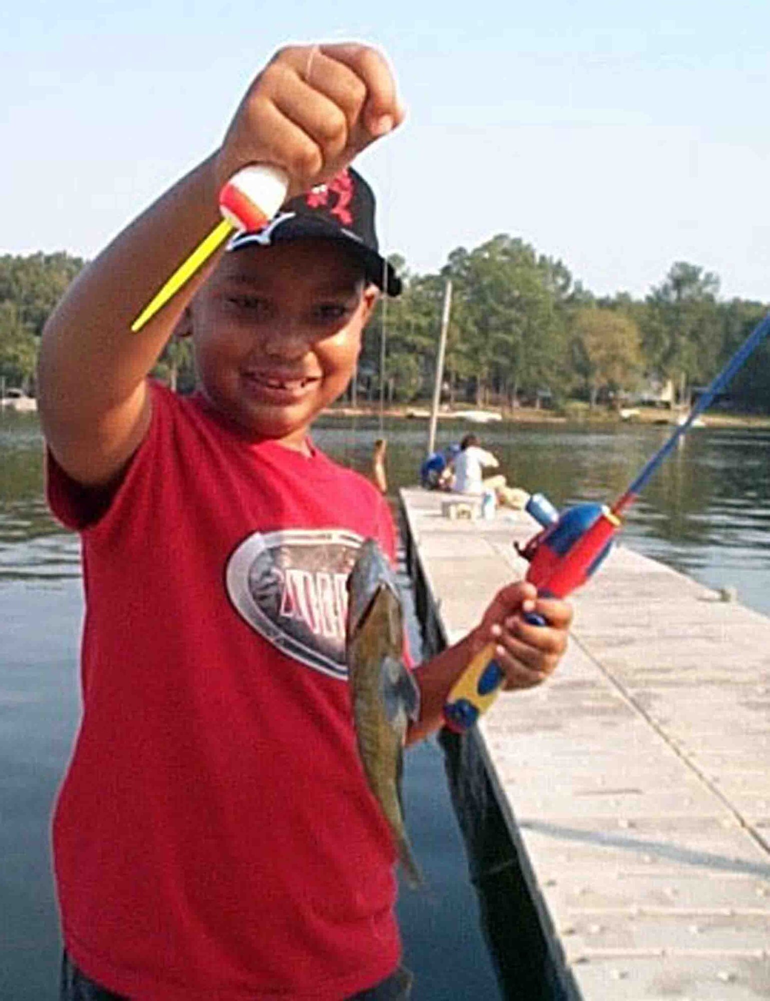 LAKE WATEREE, S.C. -- Jason, son of Kristine and Staff Sgt. Isaiah English, 55th Aircraft Maintenance Squadron, shows off the first fish he has ever caught during the End of Summer Kids fishing tournament Aug. 18 at Lake Wateree. There were 17 children who participated in the event. Trophies and ribbons were handed to the children who caught the most fish as well as the biggest fish. (Courtesy photo)